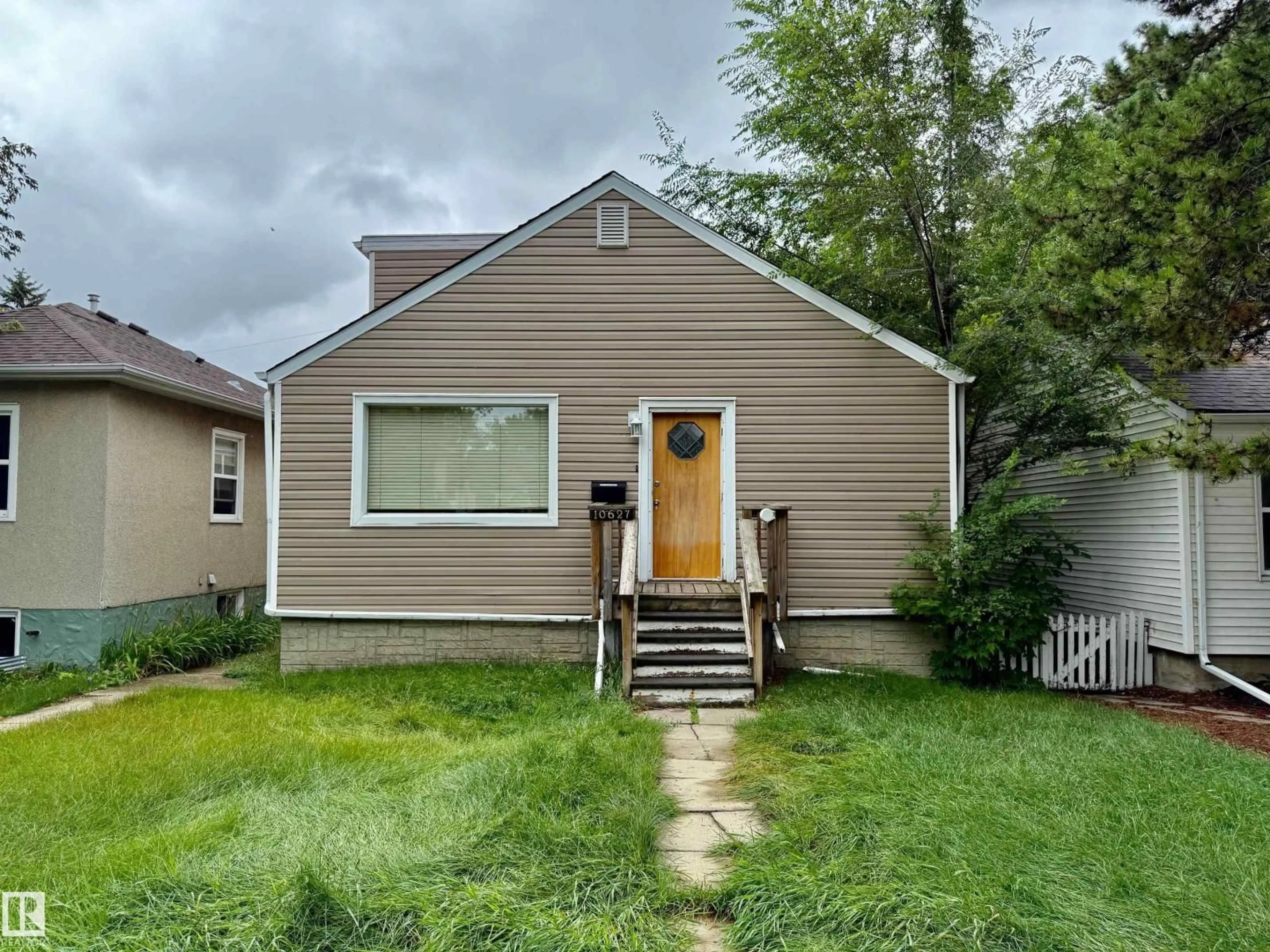 Home with vinyl exterior material, street for 10627 76 AV, Edmonton Alberta T6E1K8