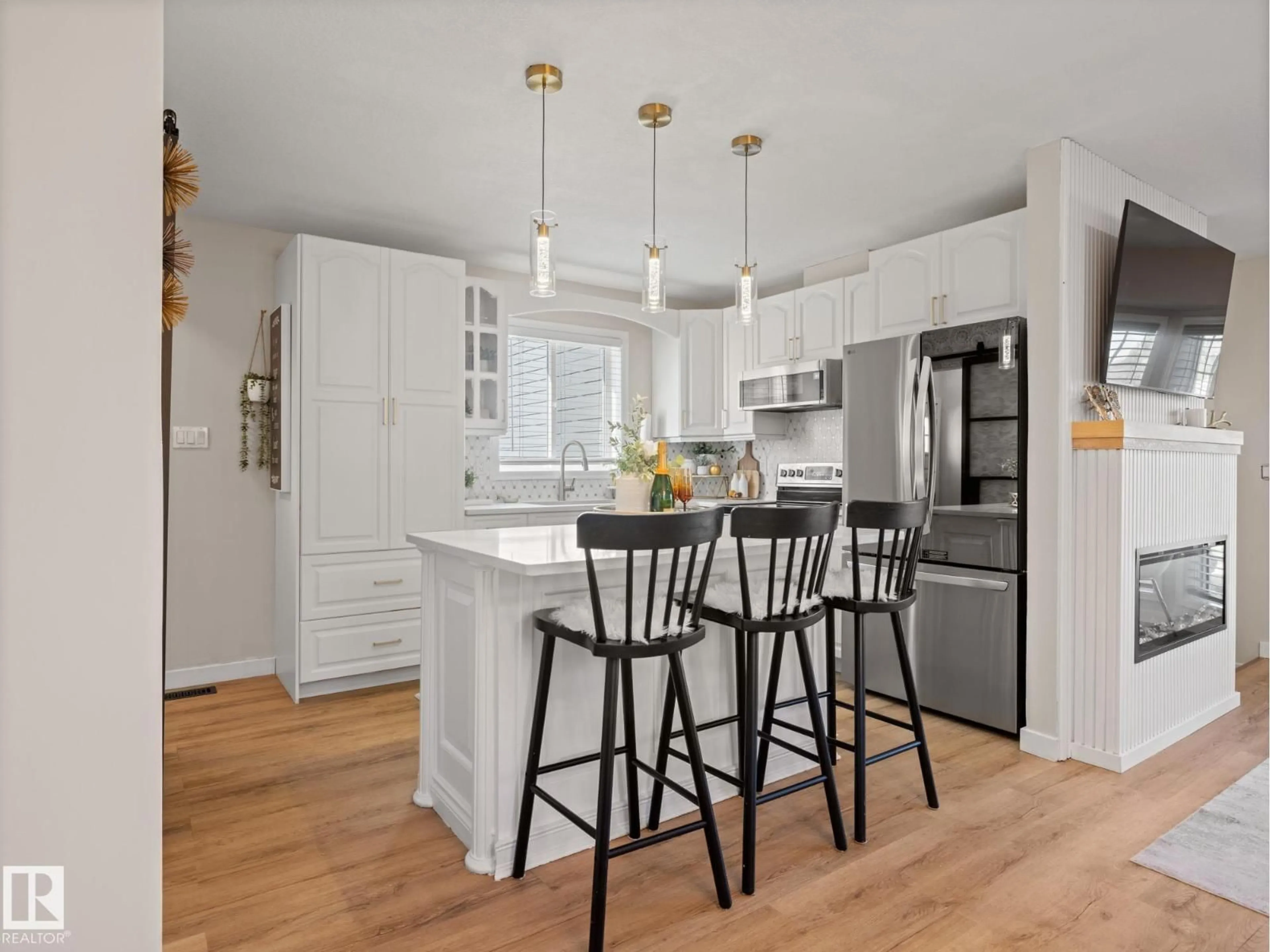 Open concept kitchen, wood/laminate floor for 10311 87A ST, Morinville Alberta T8R1C4