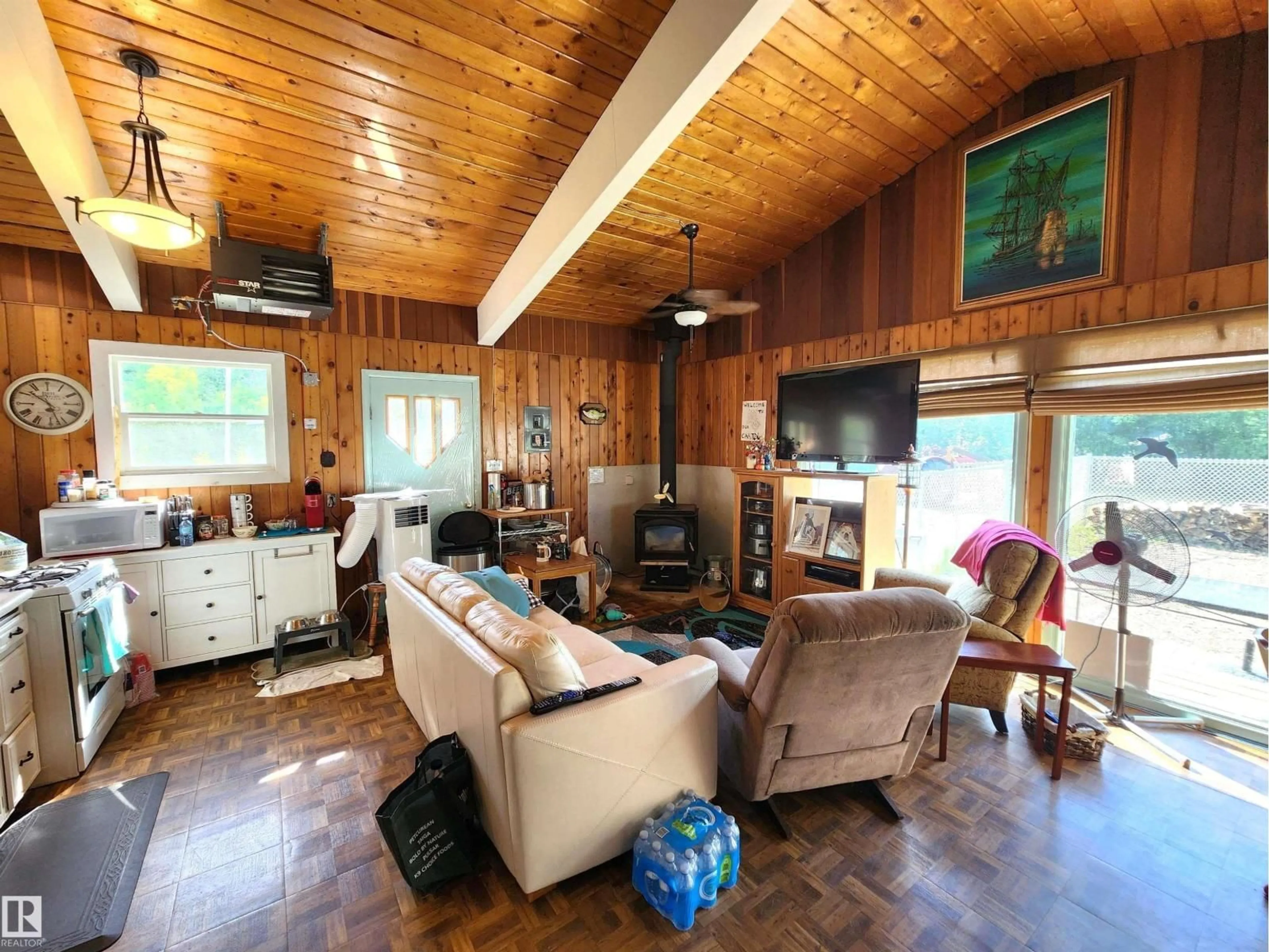 Living room with furniture, wood/laminate floor for 60032 - 122 SCNDRY, Rural St. Paul County Alberta T0A0C0