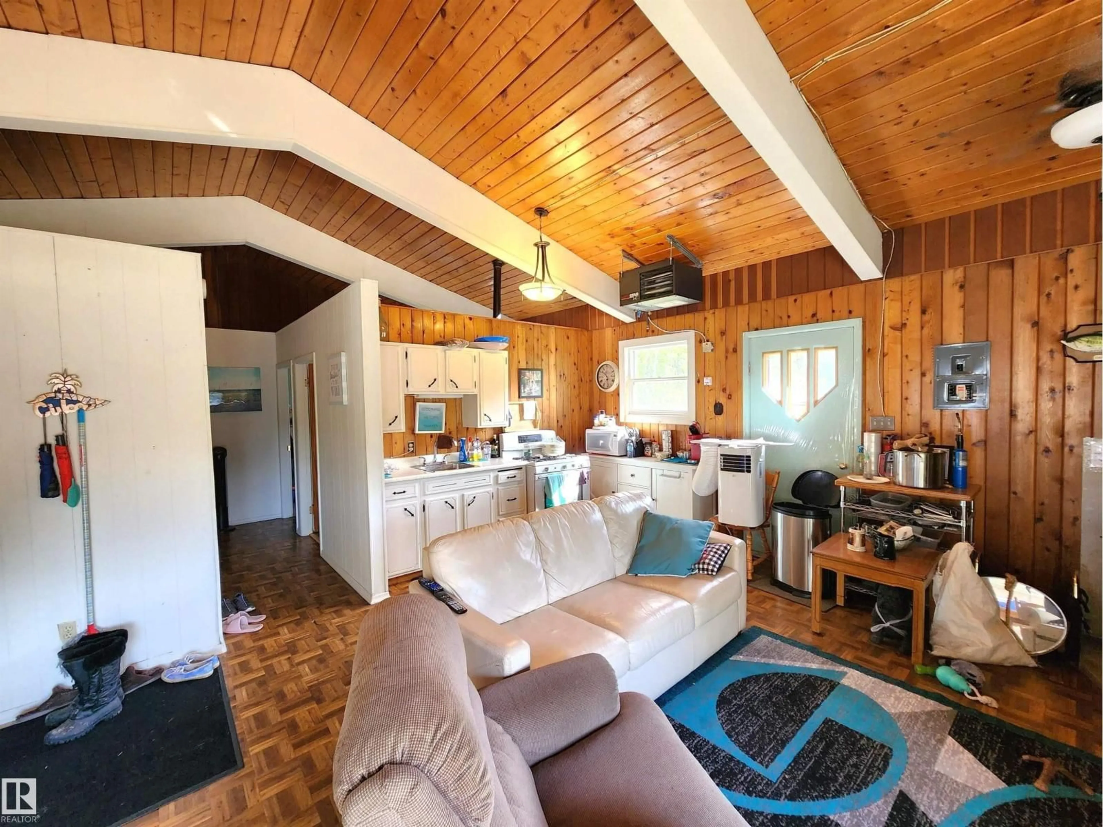 Living room with furniture, wood/laminate floor for 60032 - 122 SCNDRY, Rural St. Paul County Alberta T0A0C0