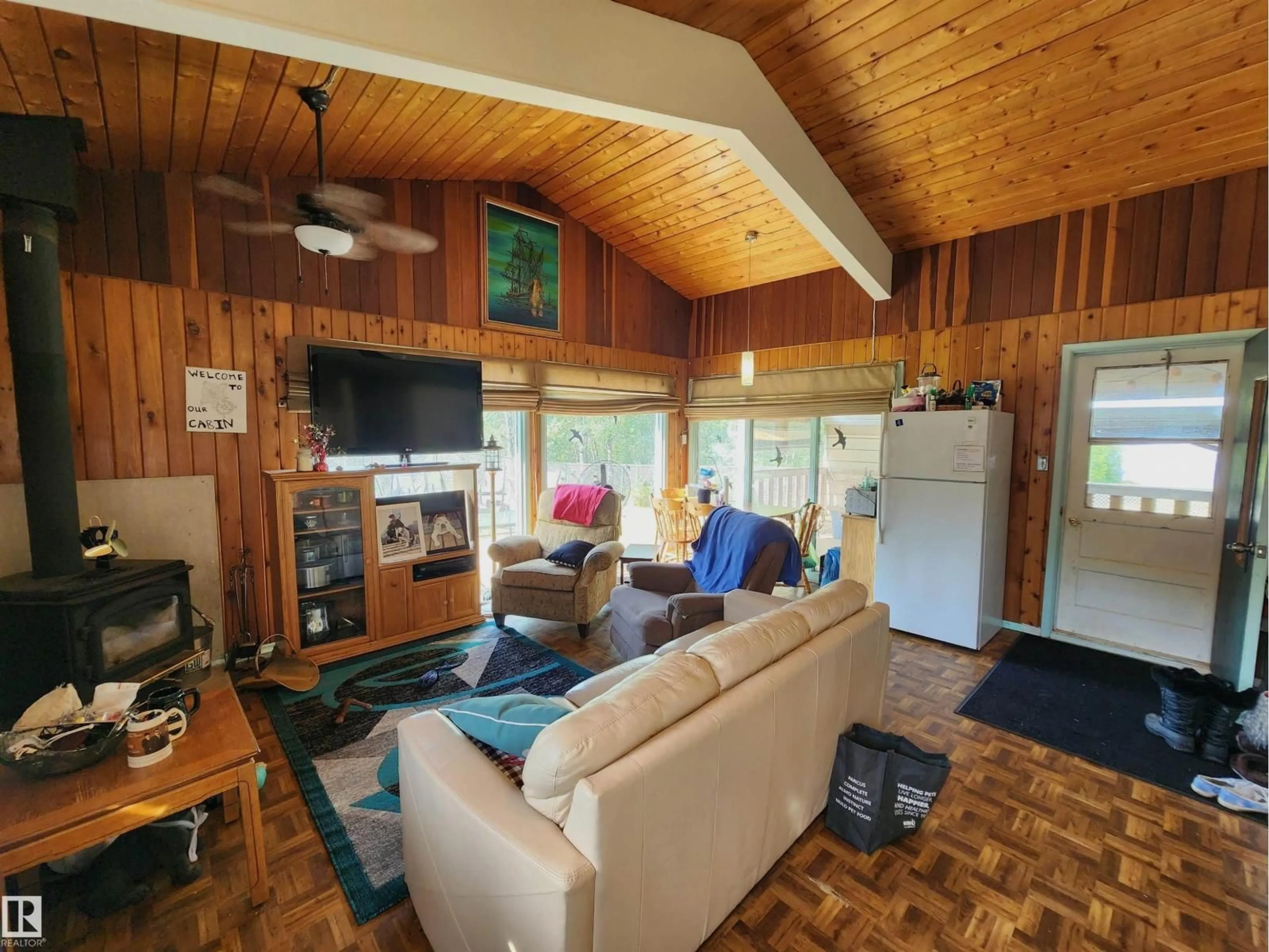 Living room with furniture, wood/laminate floor for 60032 - 122 SCNDRY, Rural St. Paul County Alberta T0A0C0