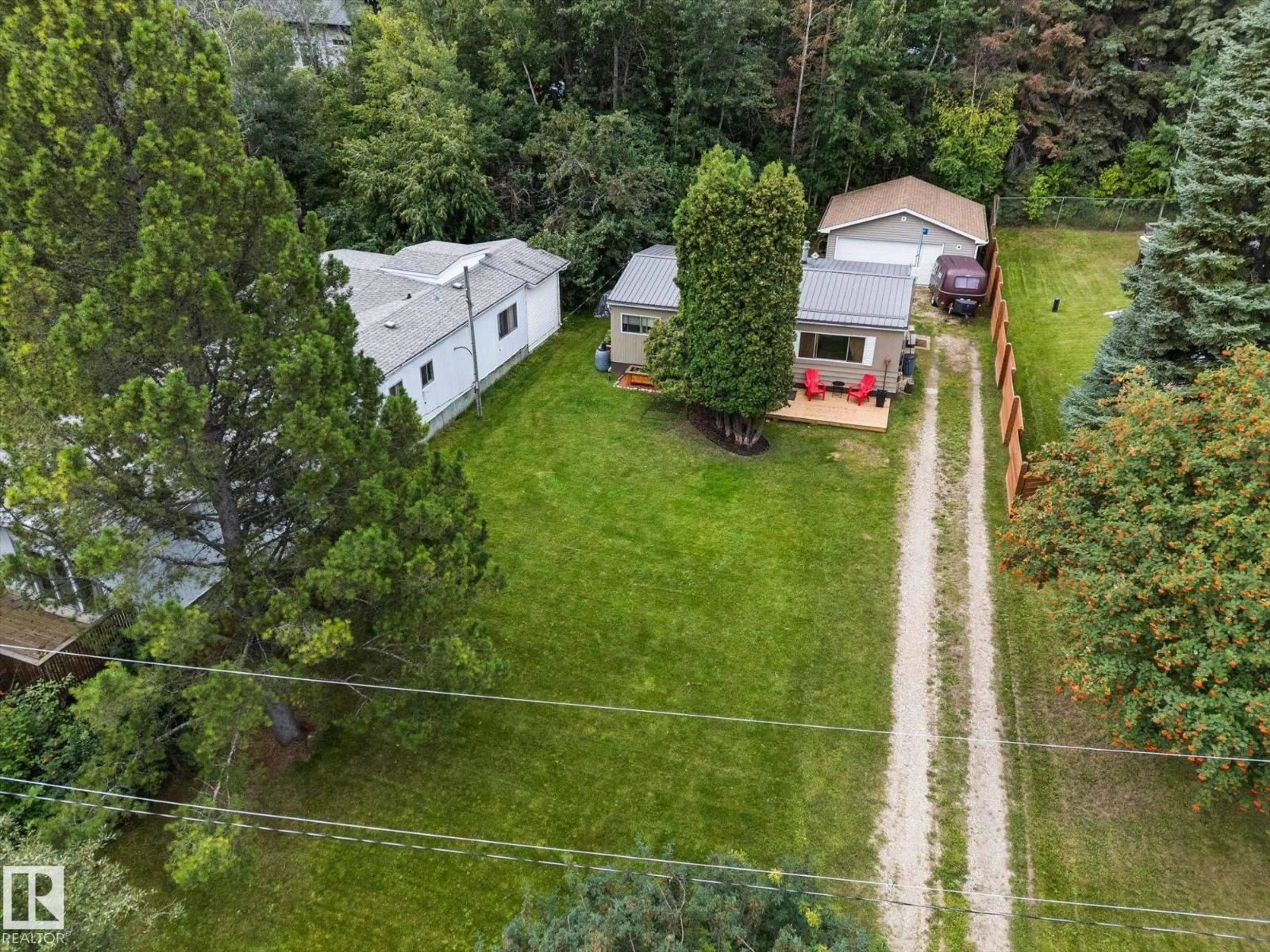 A pic from outside/outdoor area/front of a property/back of a property/a pic from drone, street for 105 - 53129 RGE ROAD 14, Rural Parkland County Alberta T7Y2T3