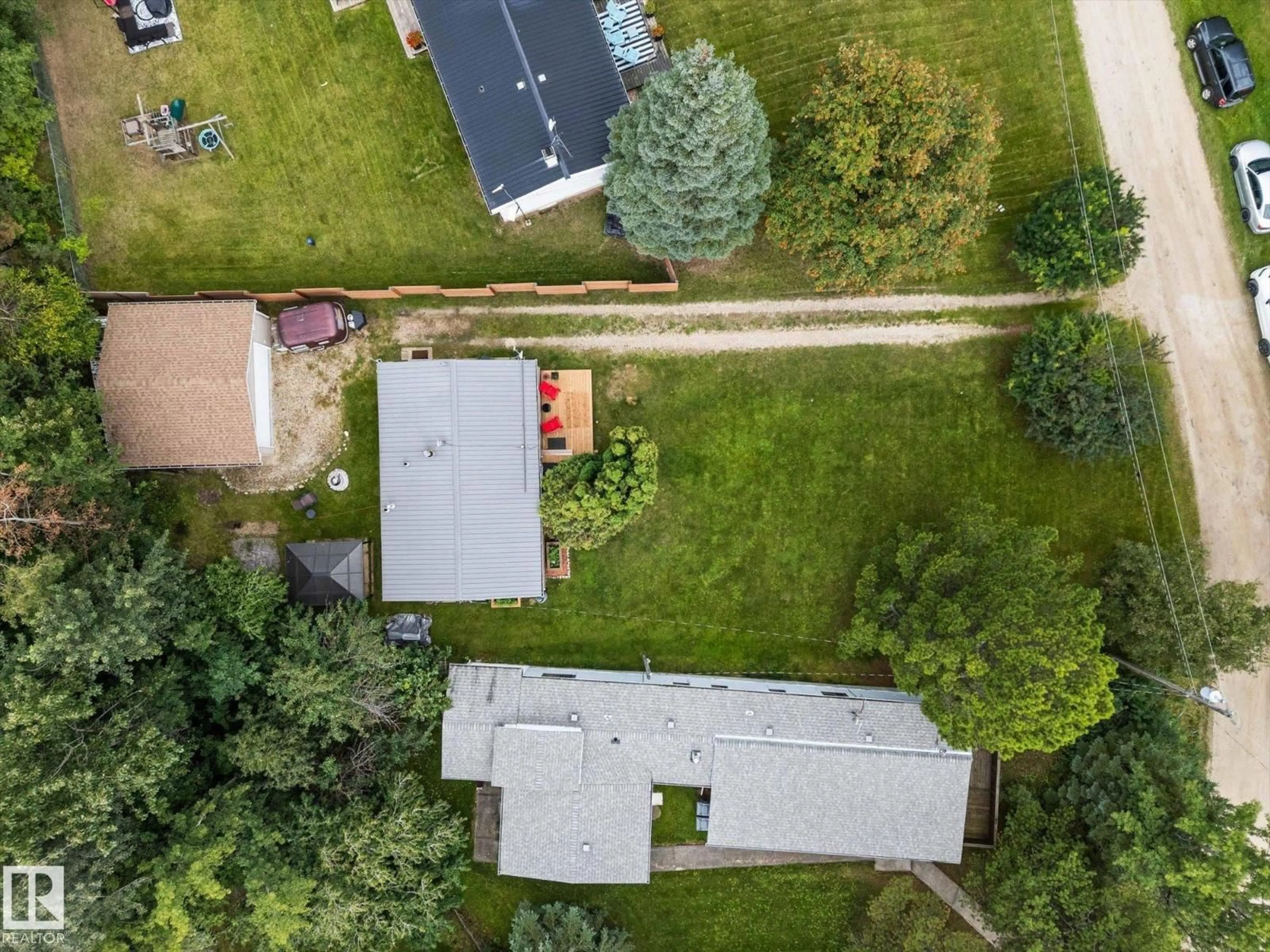 A pic from outside/outdoor area/front of a property/back of a property/a pic from drone, street for 105 - 53129 RGE ROAD 14, Rural Parkland County Alberta T7Y2T3