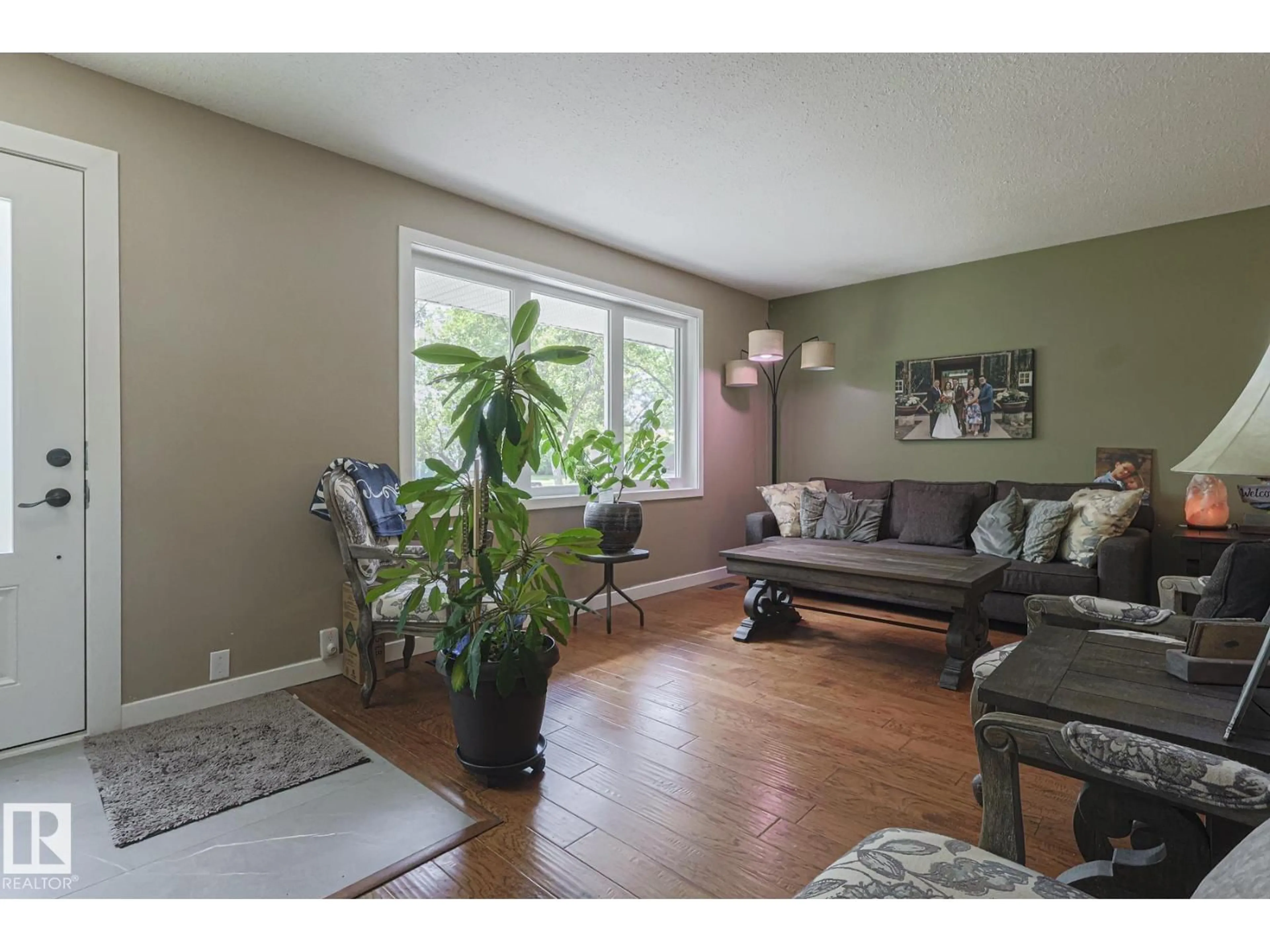 Living room with furniture, wood/laminate floor for 8948 95 AV, Fort Saskatchewan Alberta T8L1C3