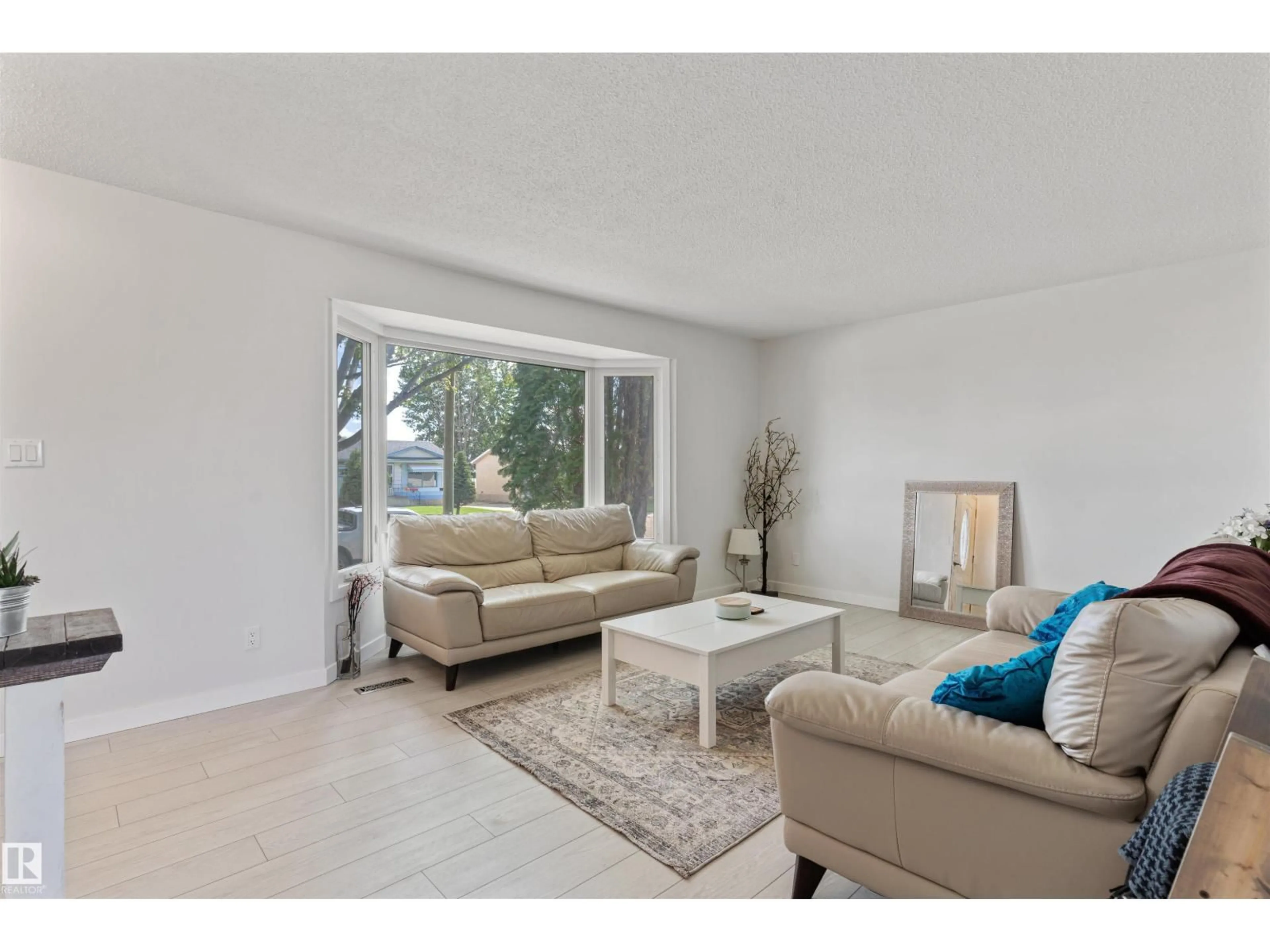 Living room with furniture, wood/laminate floor for 5614 48A ST, Vegreville Alberta T9C1G7