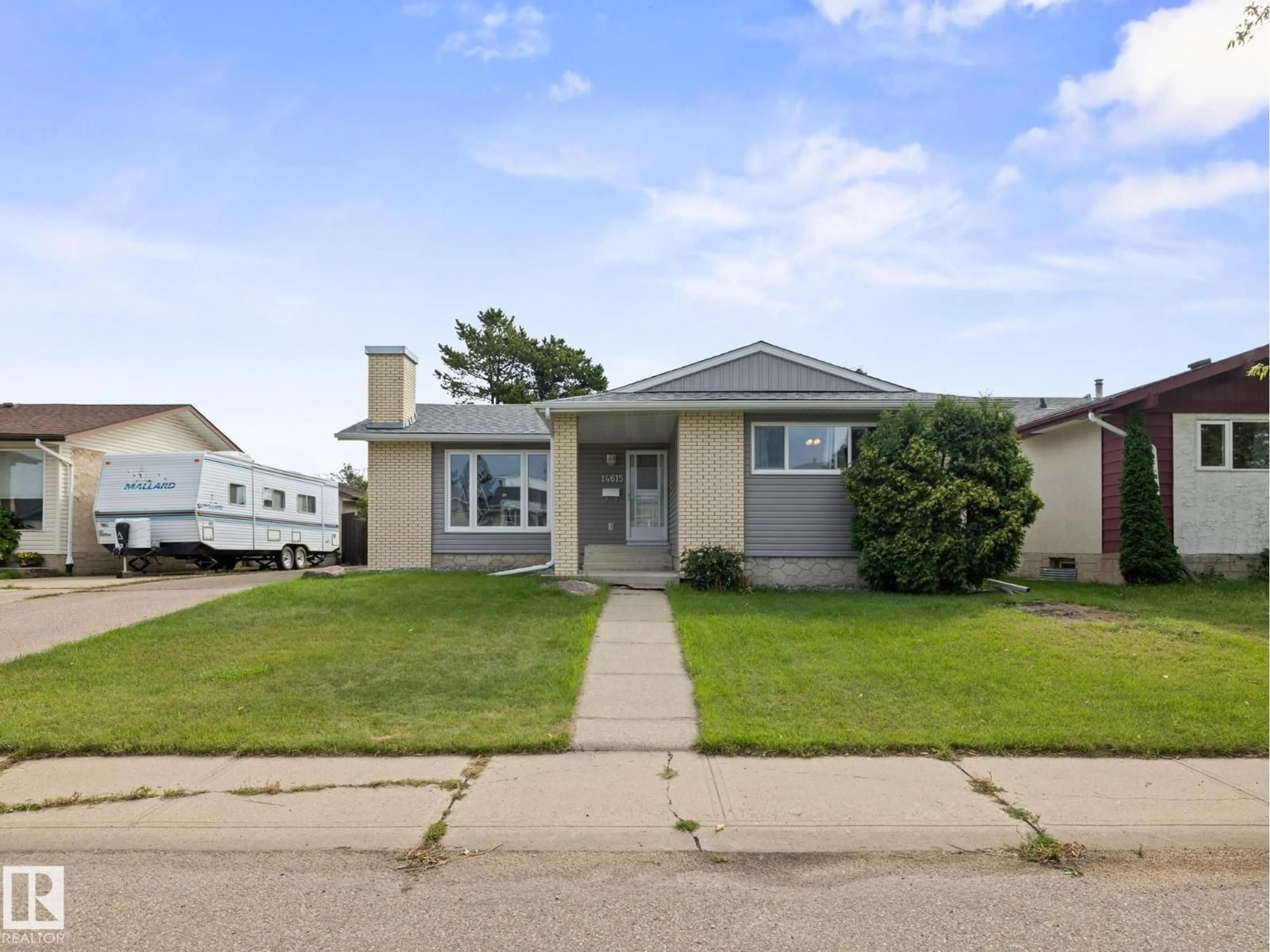 Home with vinyl exterior material, street for 14615 116 ST NW, Edmonton Alberta T5X1J4