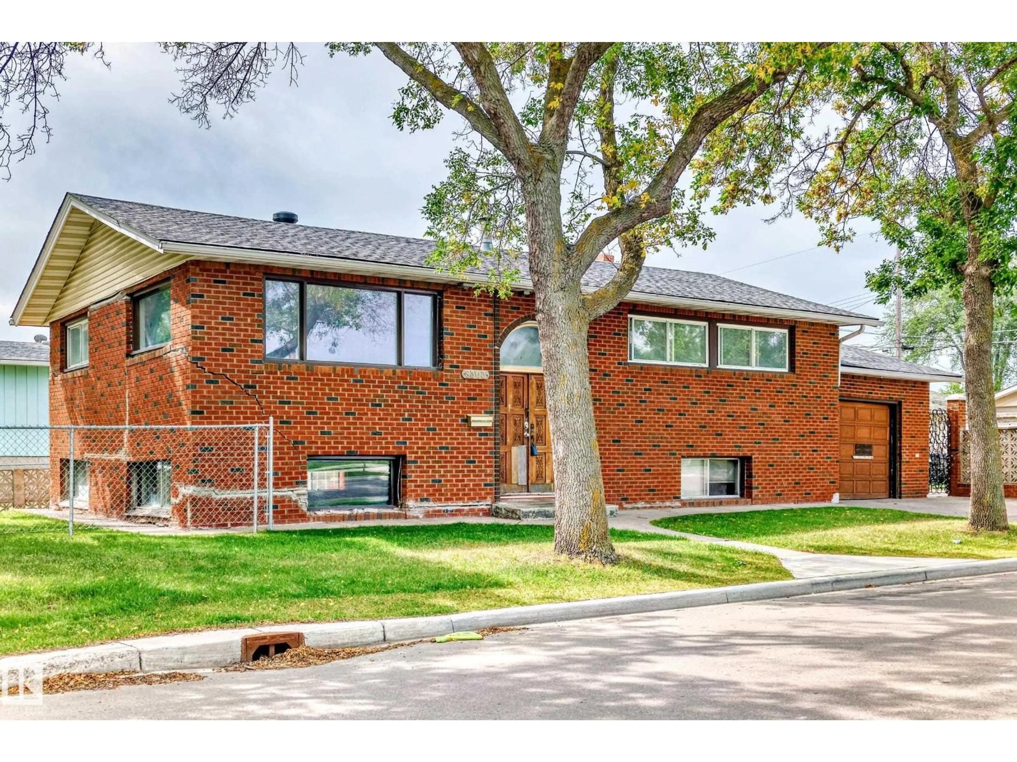 Home with brick exterior material, street for 8303 124 AV, Edmonton Alberta T5B1C3