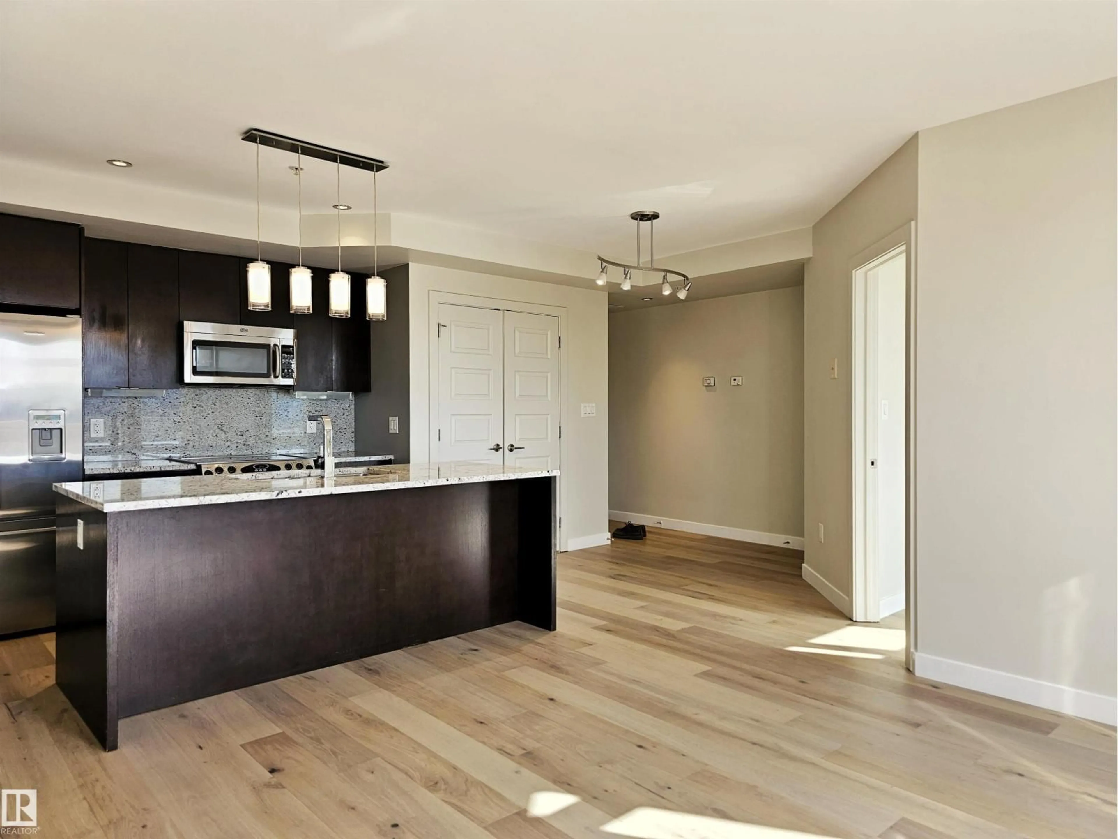 Open concept kitchen, wood/laminate floor for 701 - 10388 105 ST NW, Edmonton Alberta T5J0C2
