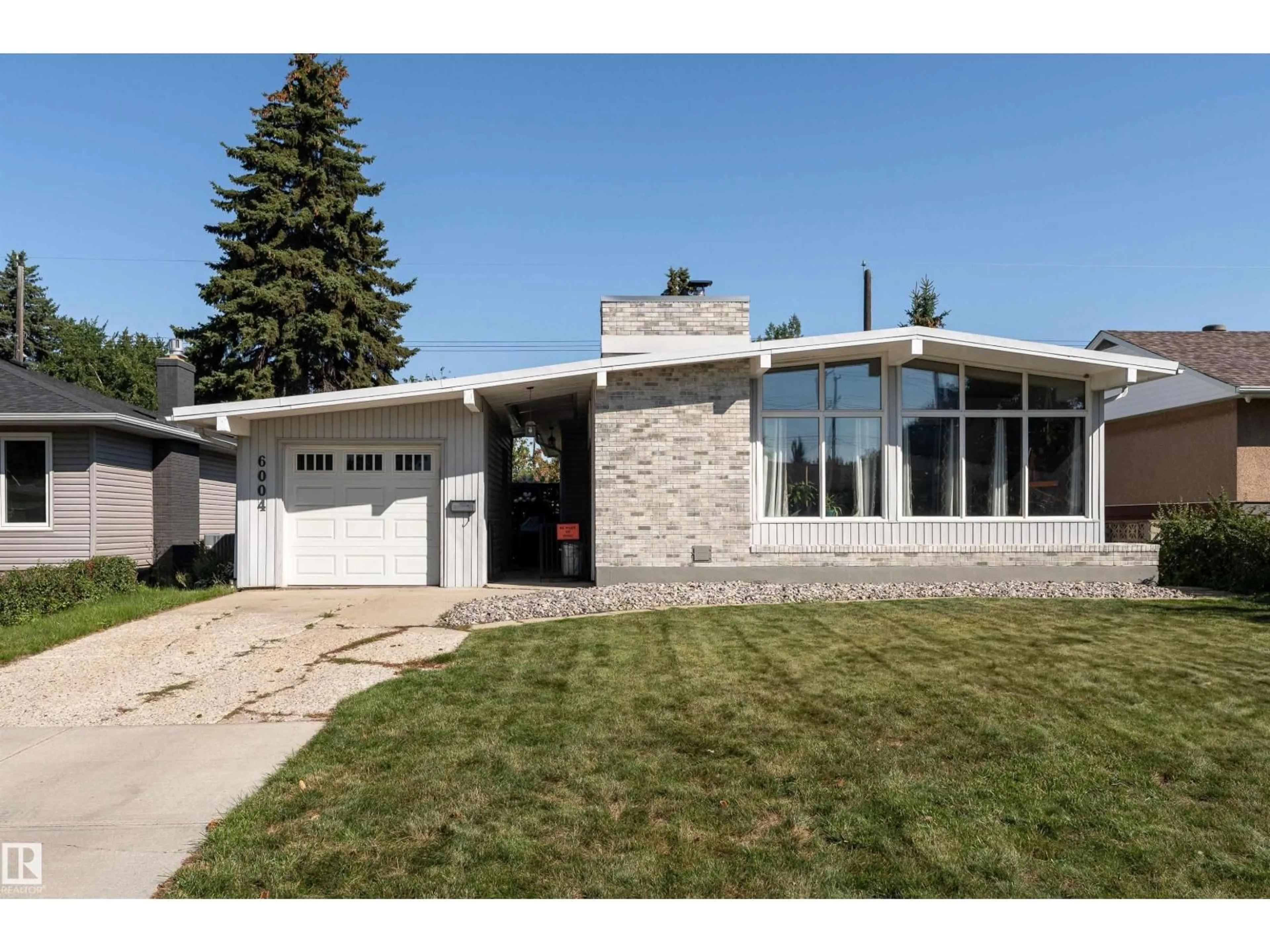 Home with vinyl exterior material, street for 6004 102 AV, Edmonton Alberta T6A0N4