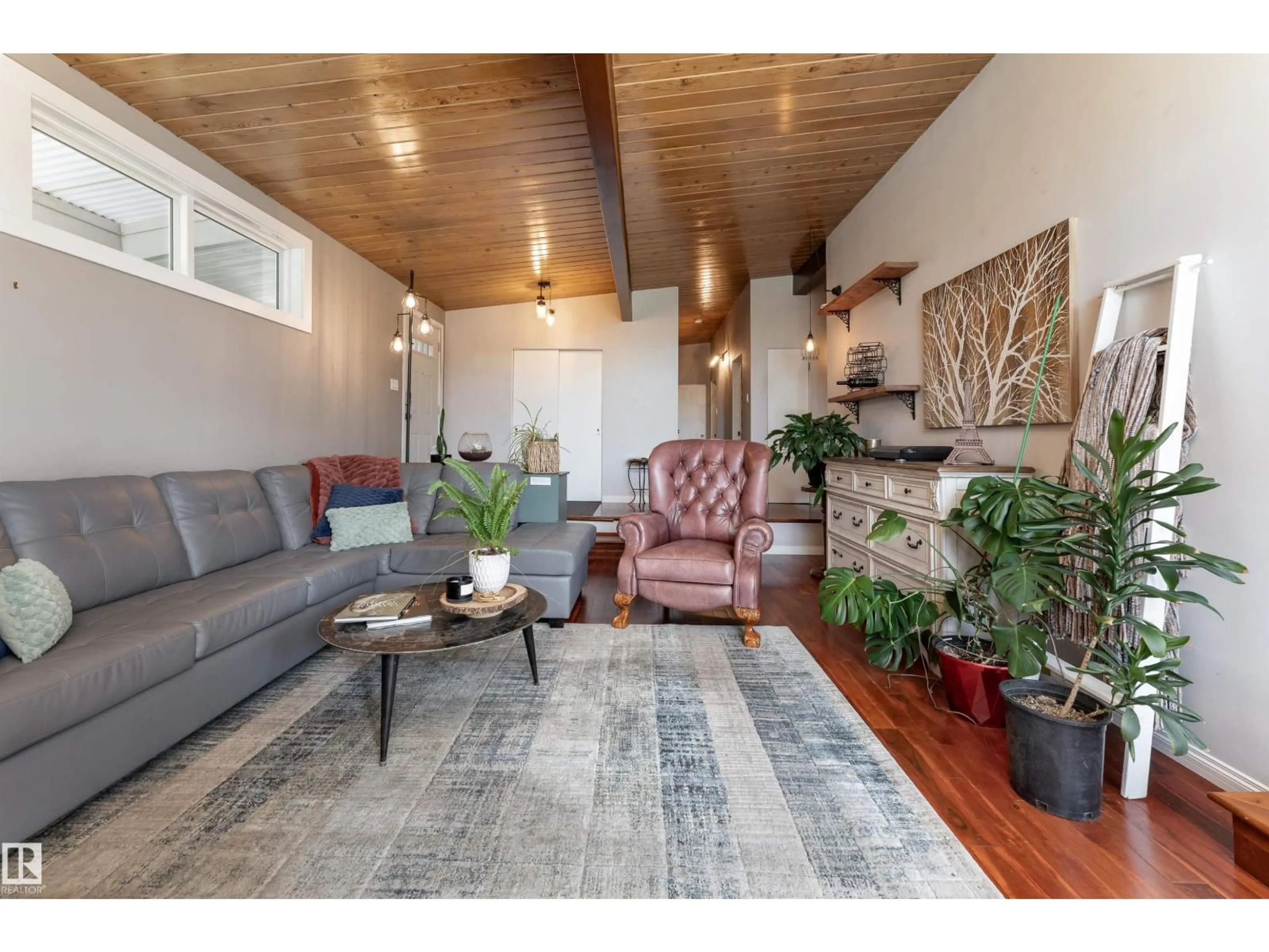 Living room with furniture, wood/laminate floor for 6004 102 AV, Edmonton Alberta T6A0N4