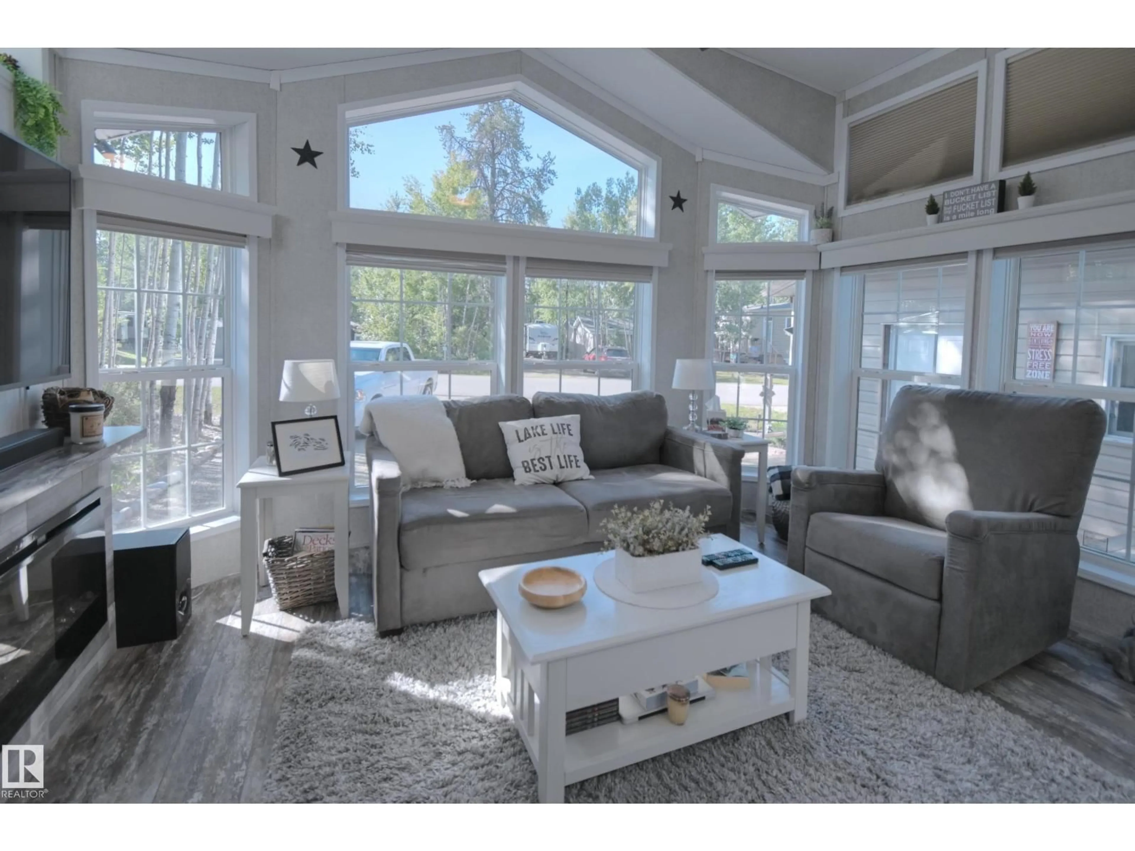 Living room with furniture, wood/laminate floor for 64 53206 RGE ROAD 55 A, Rural Parkland County Alberta T0E2B0