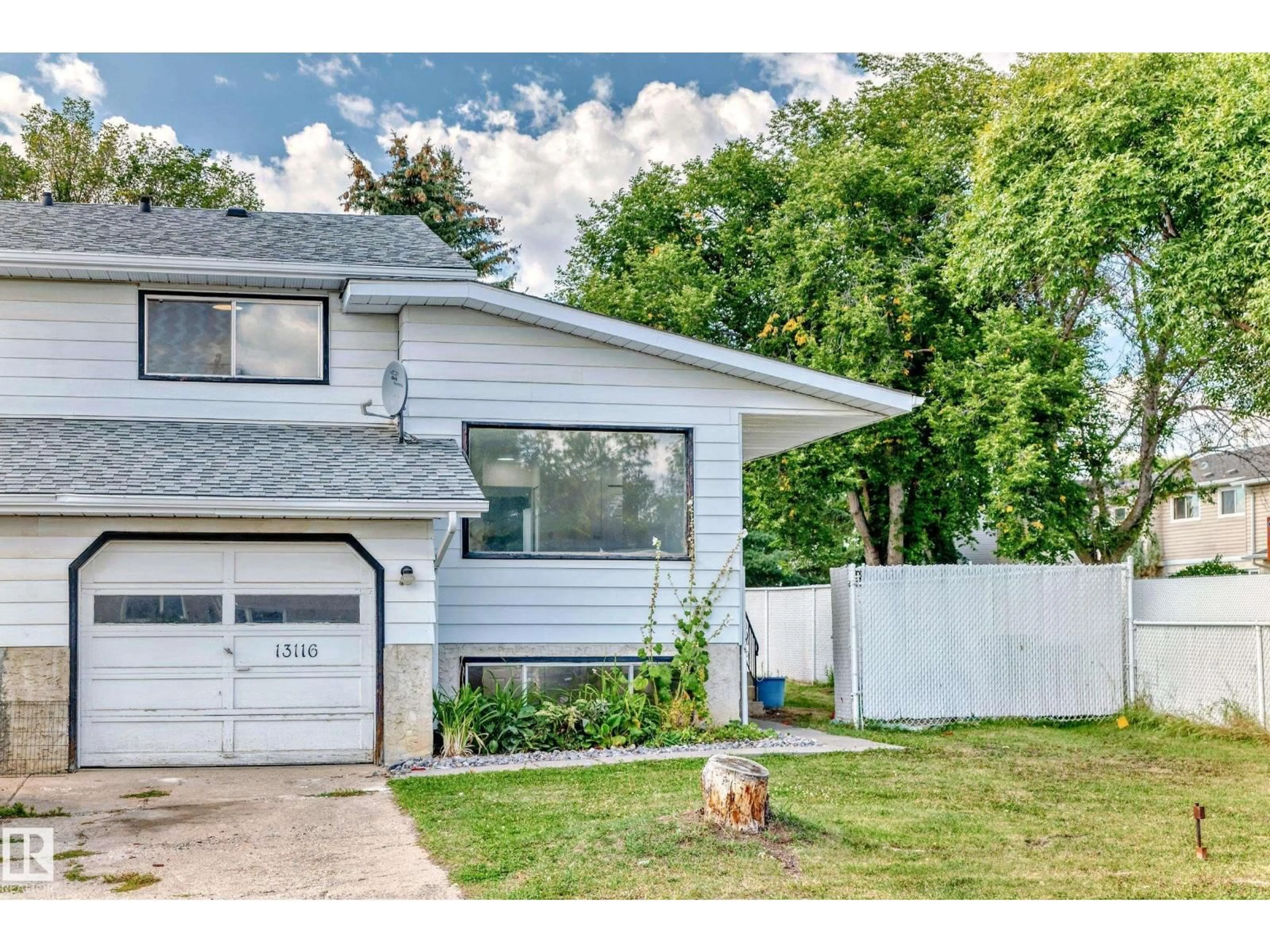 Home with vinyl exterior material, street for NW - 13116 31 STRRET, Edmonton Alberta T5A3A4