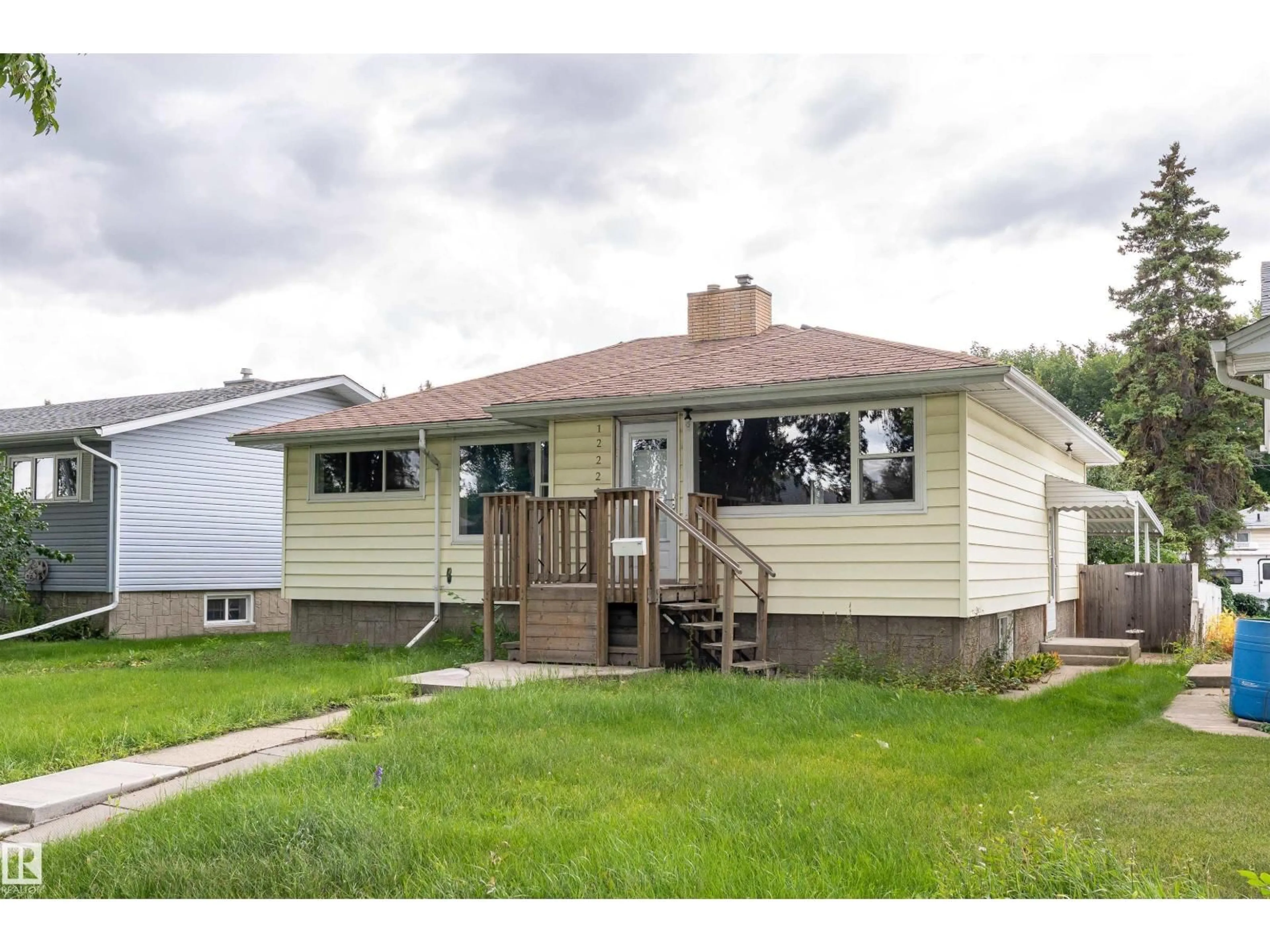 Home with vinyl exterior material, street for 12220 51 ST, Edmonton Alberta T5W3H2