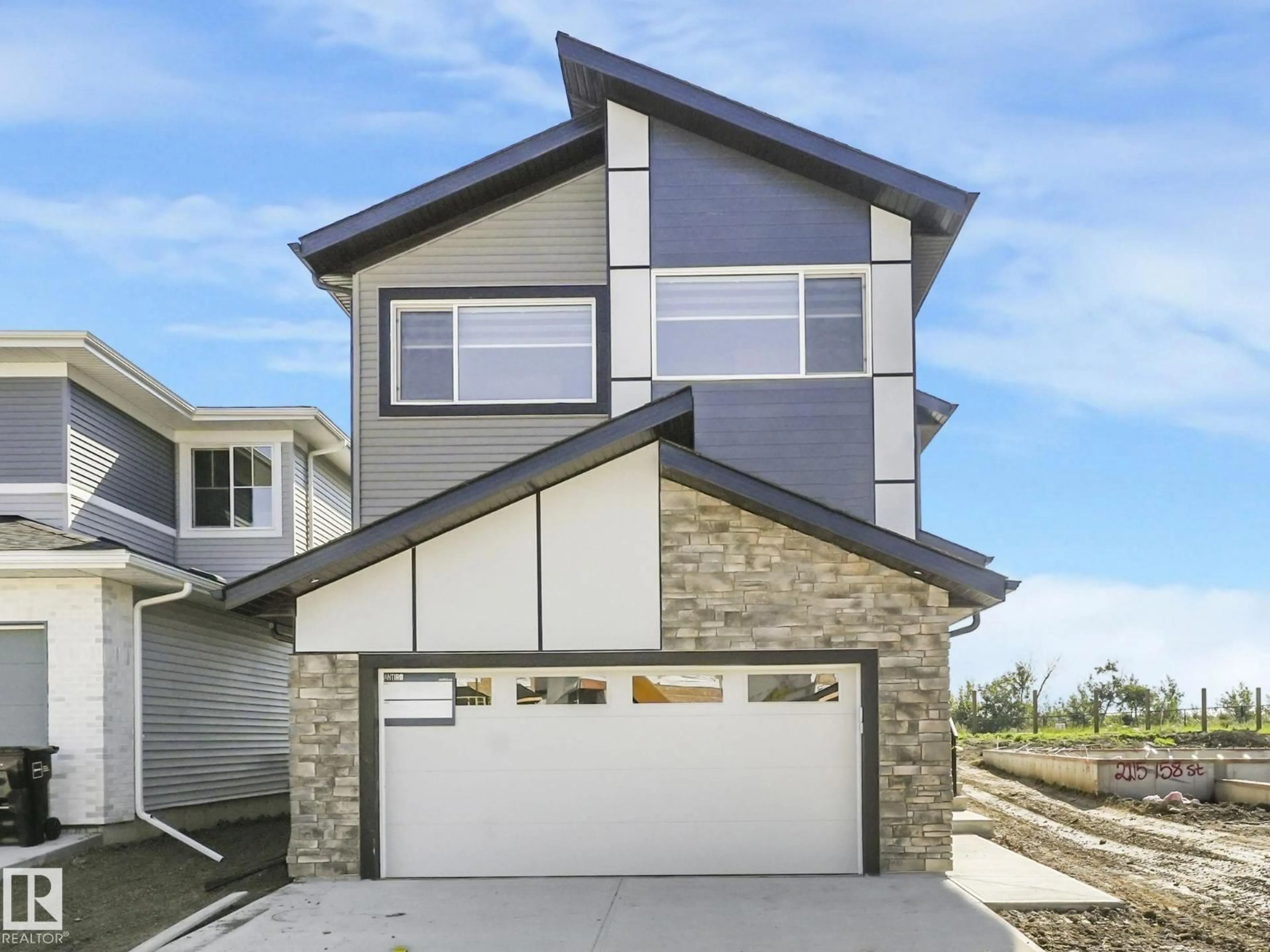 Home with vinyl exterior material, street for 2211 158 ST, Edmonton Alberta T6W5P5