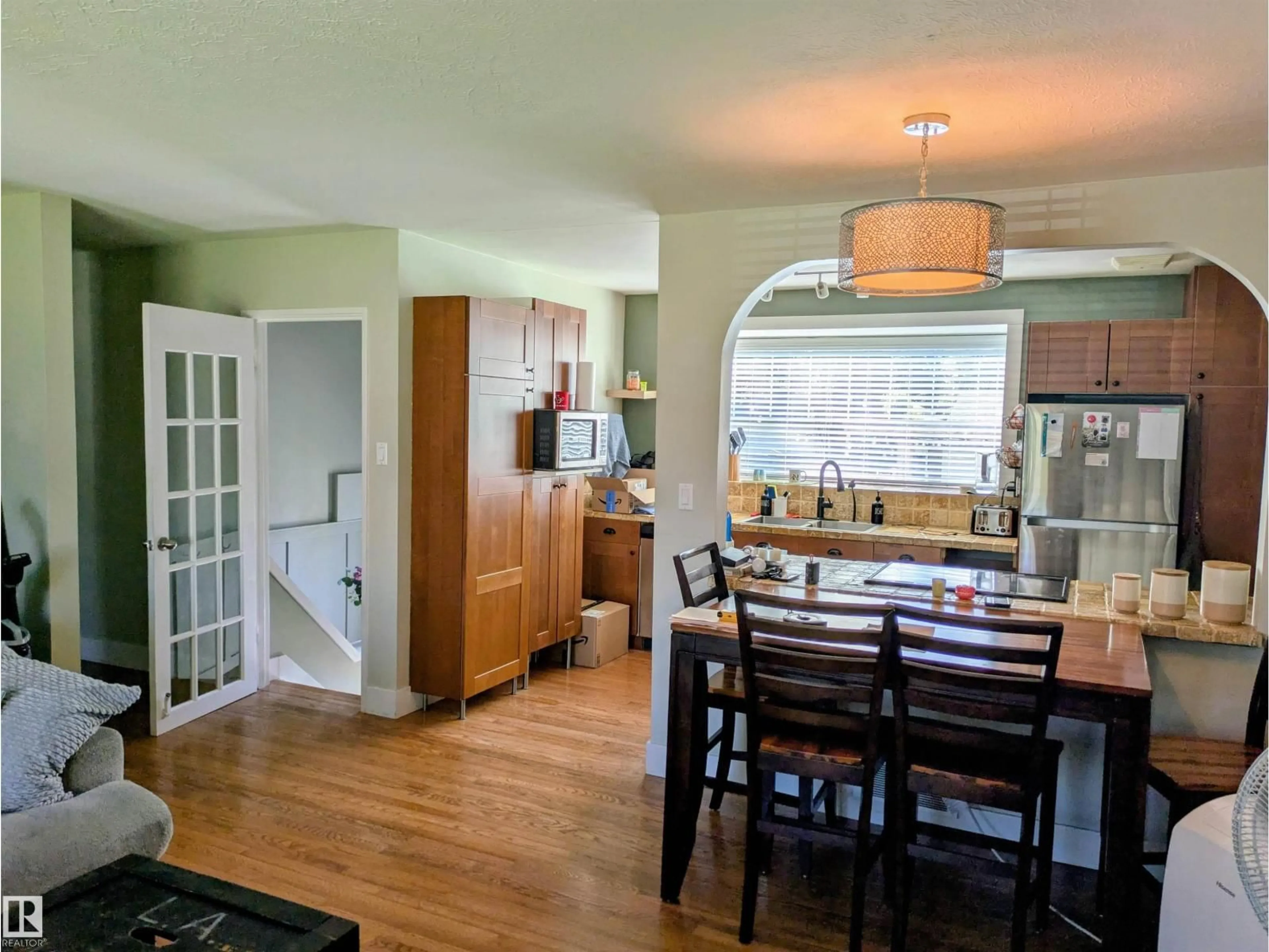 Open concept kitchen, wood/laminate floor for 14347 92A AV, Edmonton Alberta T5R5E3