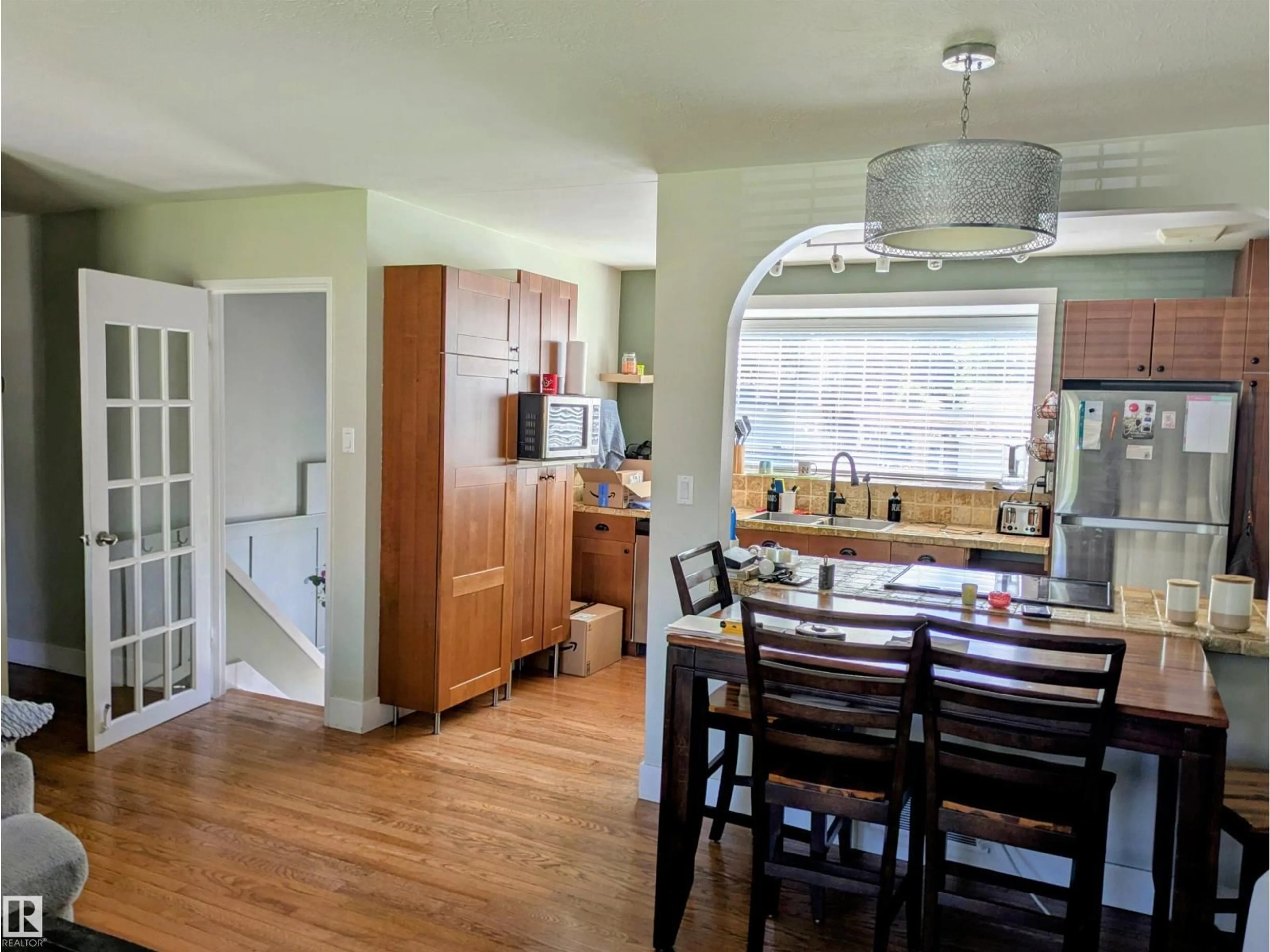 Open concept kitchen, wood/laminate floor for 14347 92A AV, Edmonton Alberta T5R5E3