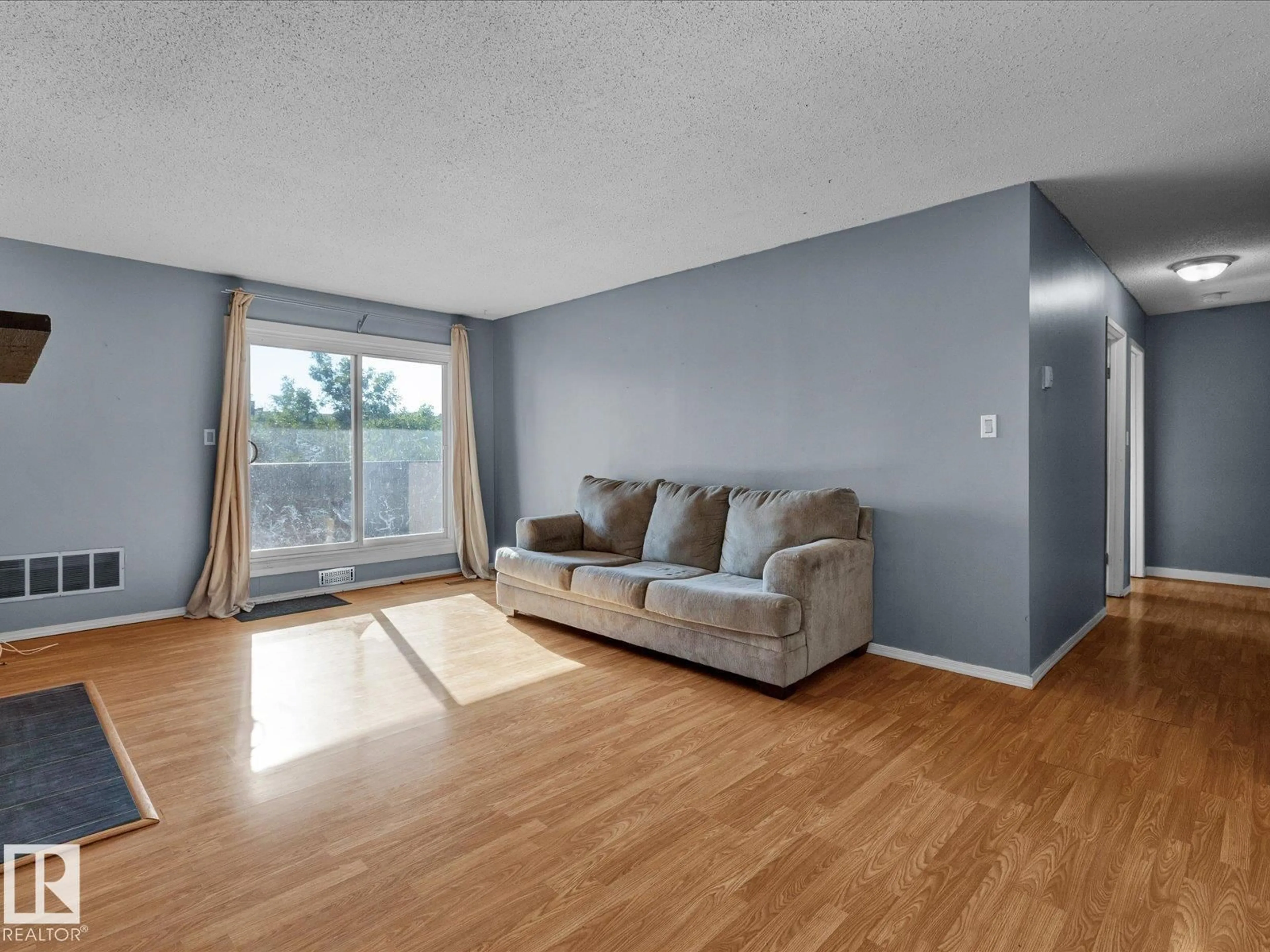 Living room with furniture, wood/laminate floor for 43 - 301 AKINS DR, St. Albert Alberta T8N1X3