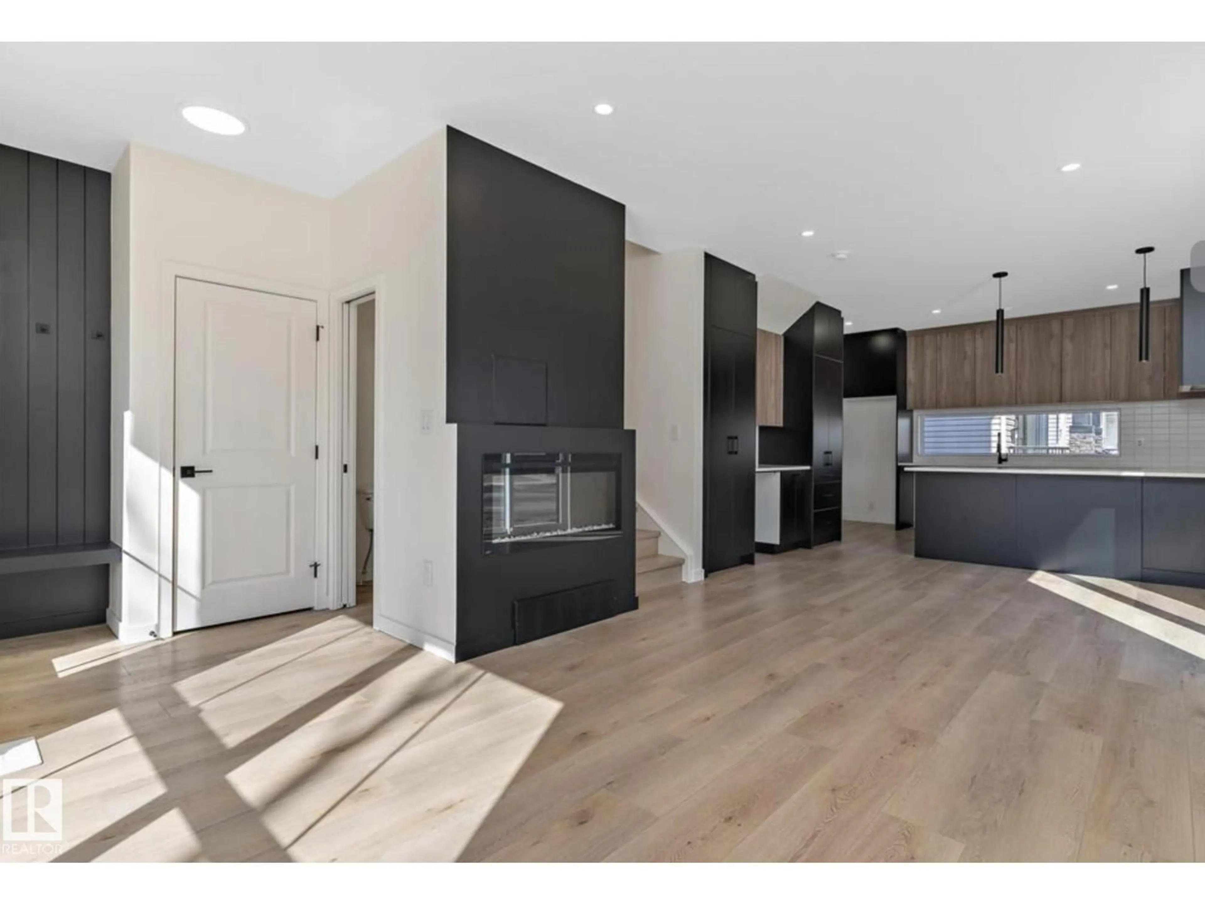 Open concept kitchen, wood/laminate floor for 8402 87 ST, Edmonton Alberta T6C1E2
