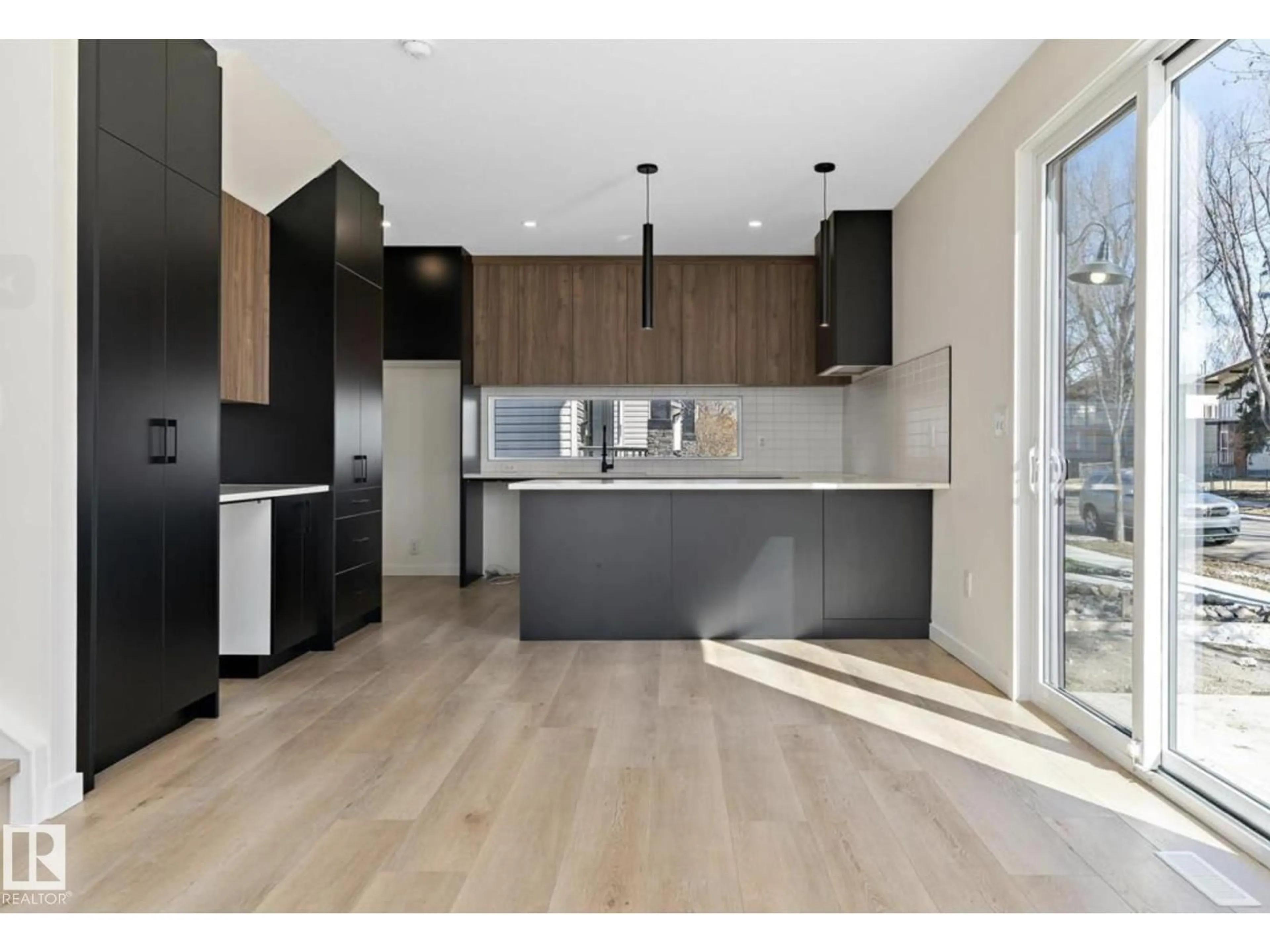 Open concept kitchen, wood/laminate floor for 8402 87 ST, Edmonton Alberta T6C1E2