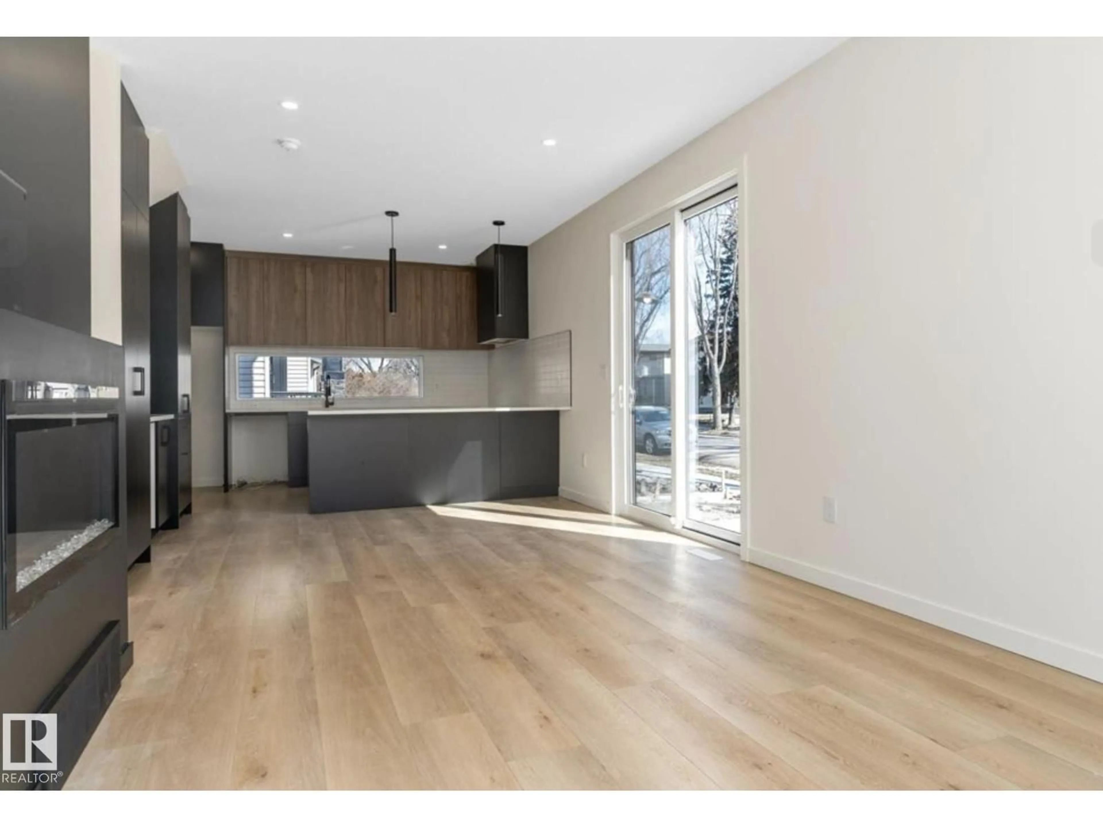 Open concept kitchen, wood/laminate floor for 8402 87 ST, Edmonton Alberta T6C1E2