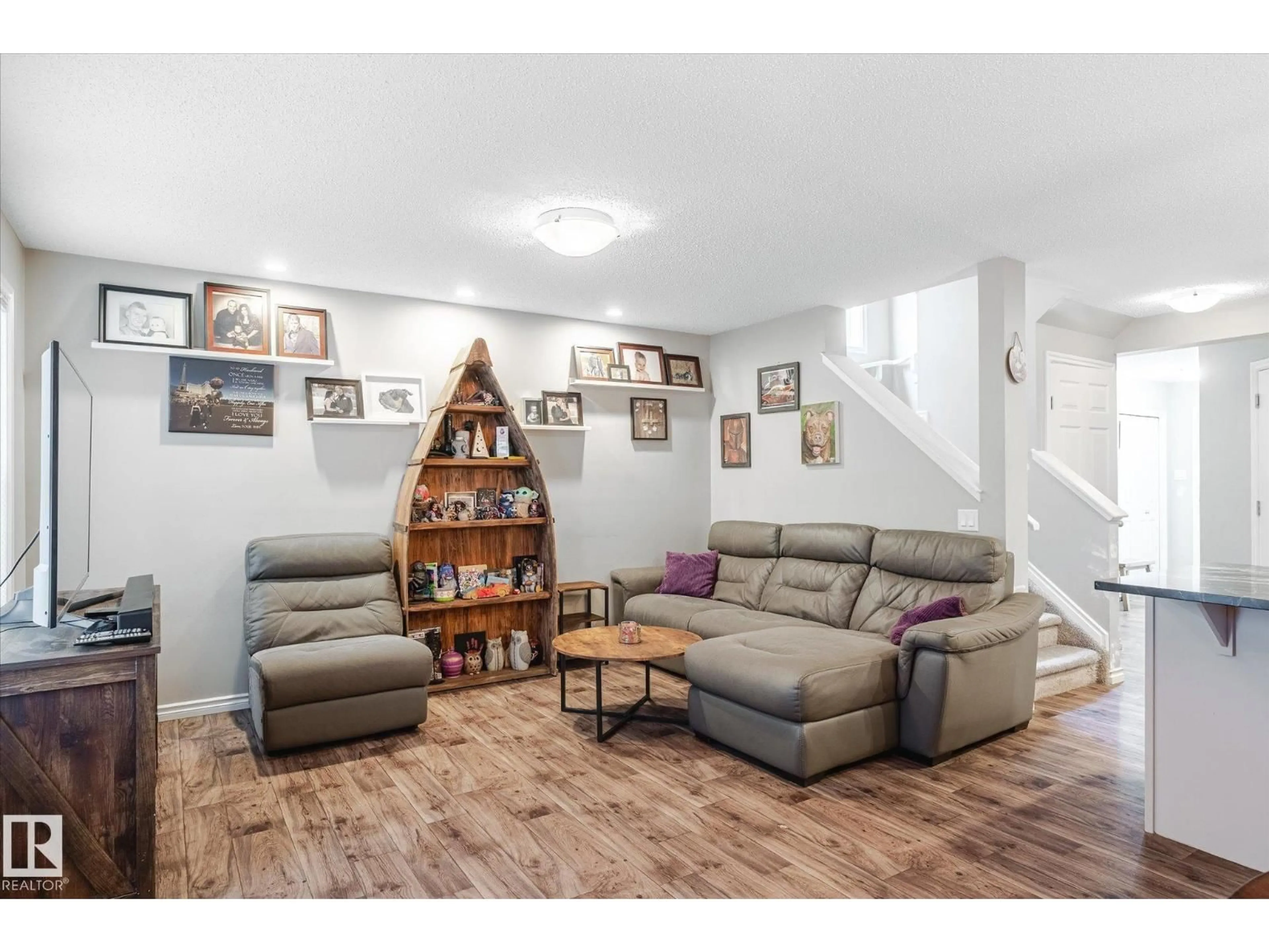Living room with furniture, wood/laminate floor for 2424 19A AV, Edmonton Alberta T6T2C9