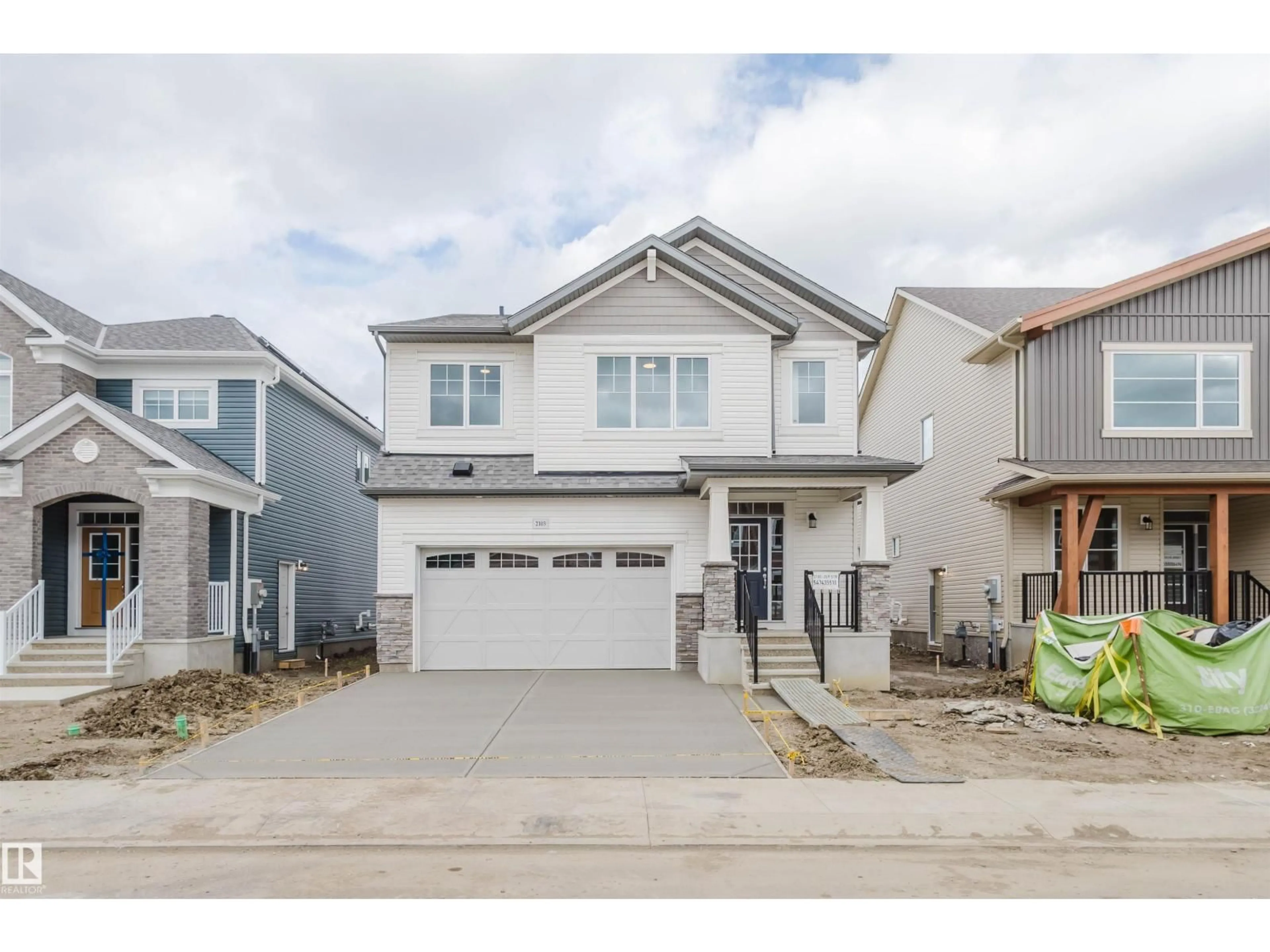 Home with vinyl exterior material, street for NW - 2103 209 ST, Edmonton Alberta T6M2X6