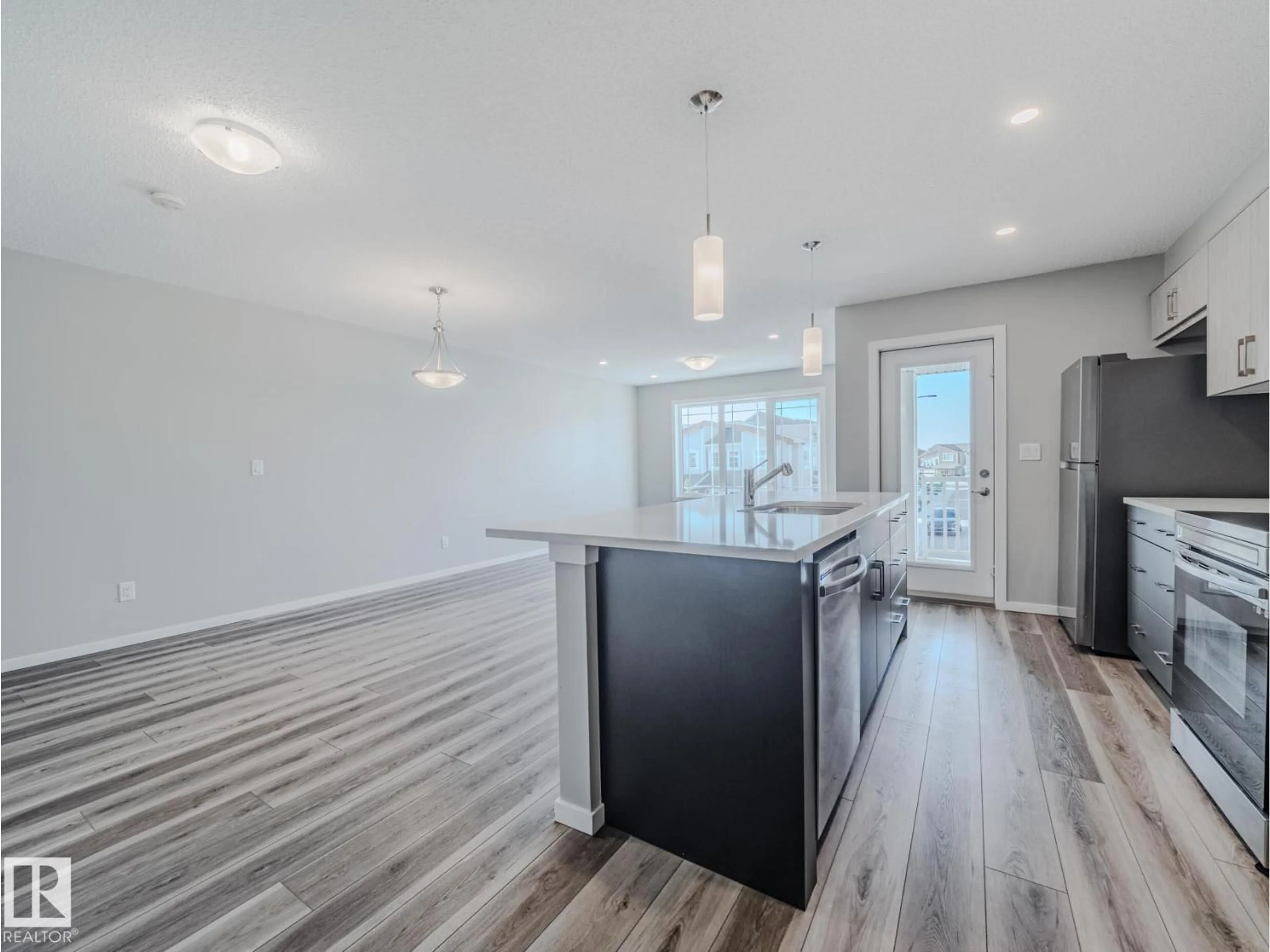Open concept kitchen, wood/laminate floor for NW - 20532 21 AV, Edmonton Alberta T6M1N2