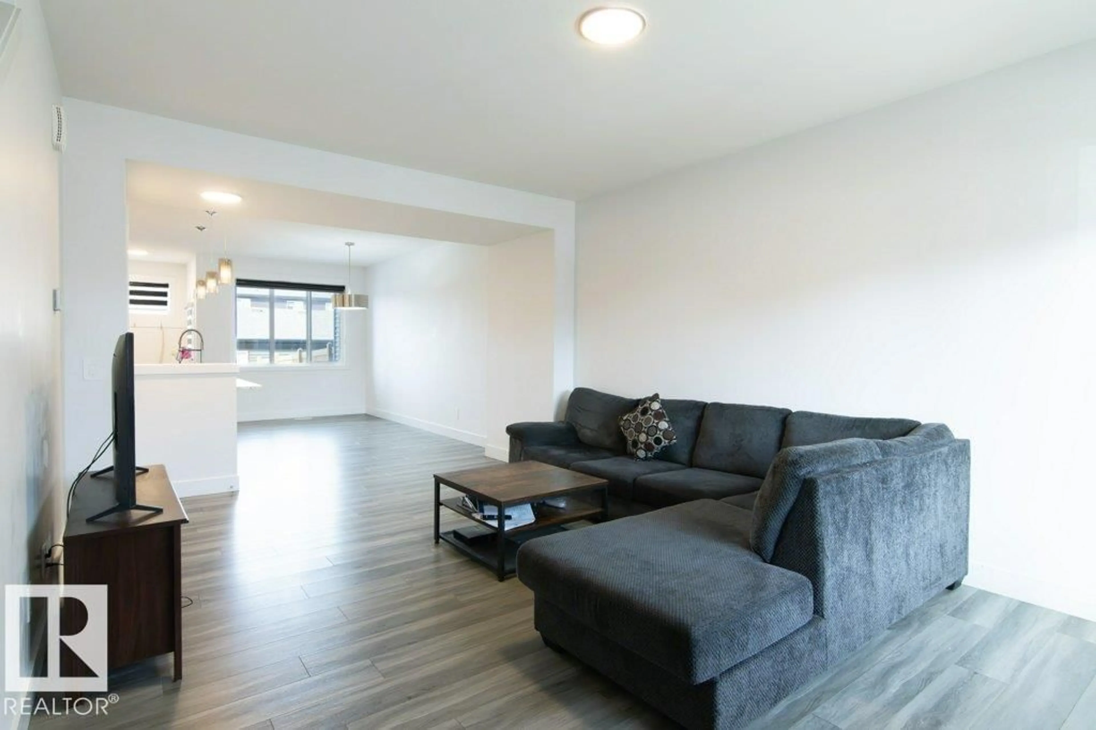 Living room with furniture, wood/laminate floor for 1434 KESWICK DR, Edmonton Alberta T6W4T9