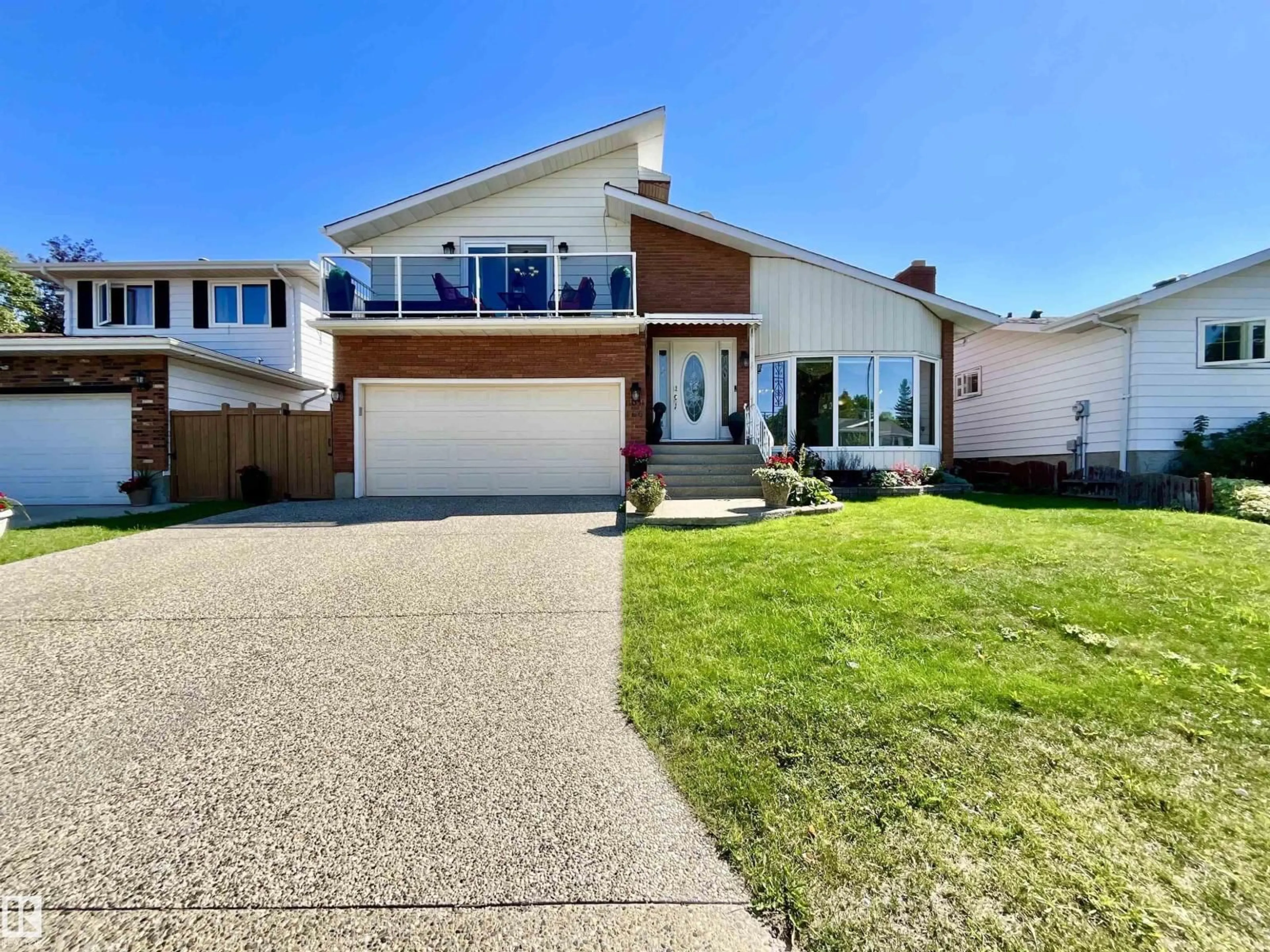 Home with vinyl exterior material, street for 11031 166 AV, Edmonton Alberta T5X1Y2