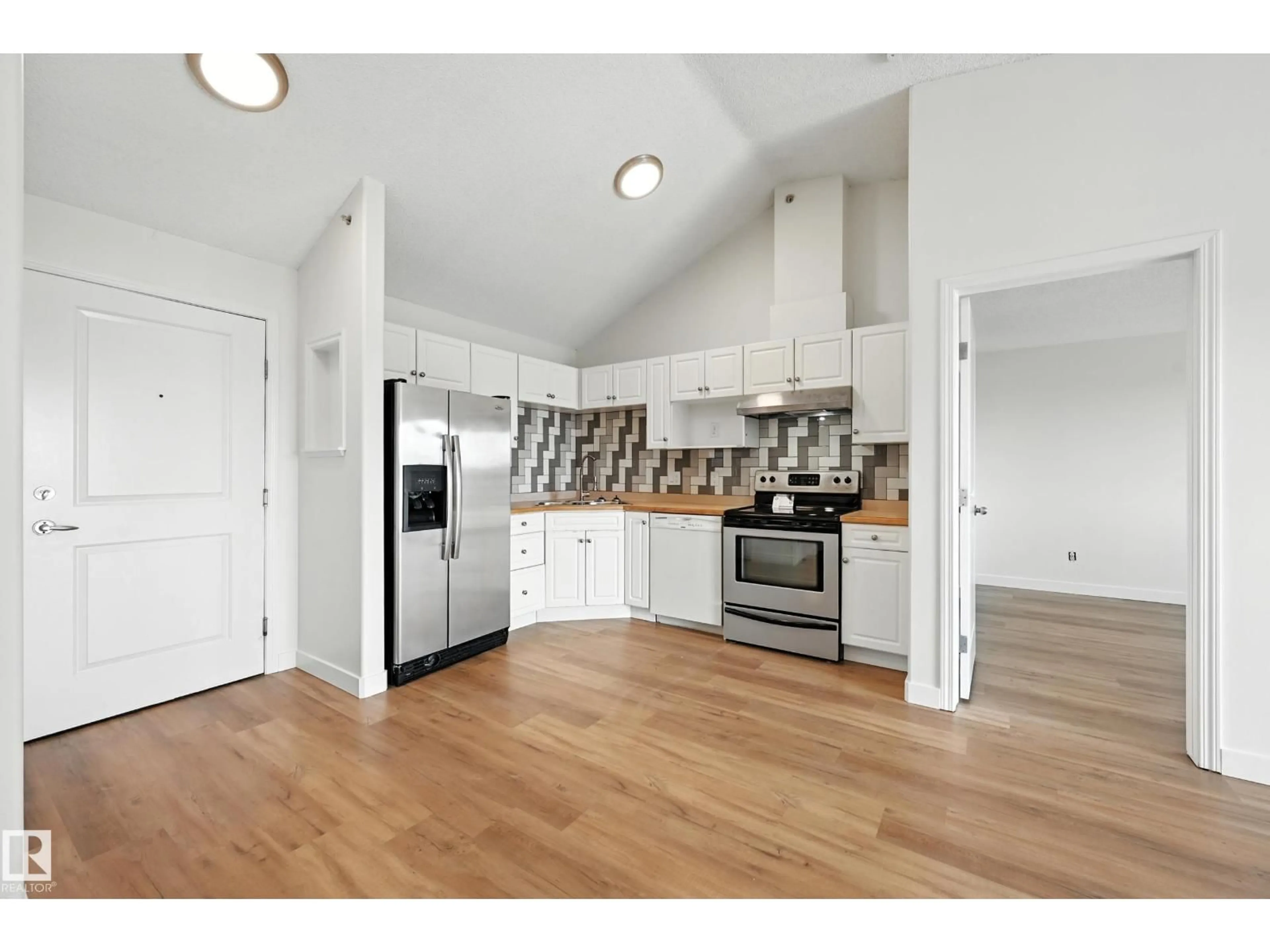 Open concept kitchen, wood/laminate floor for #417 - 245 EDWARDS DR, Edmonton Alberta T6X1J9