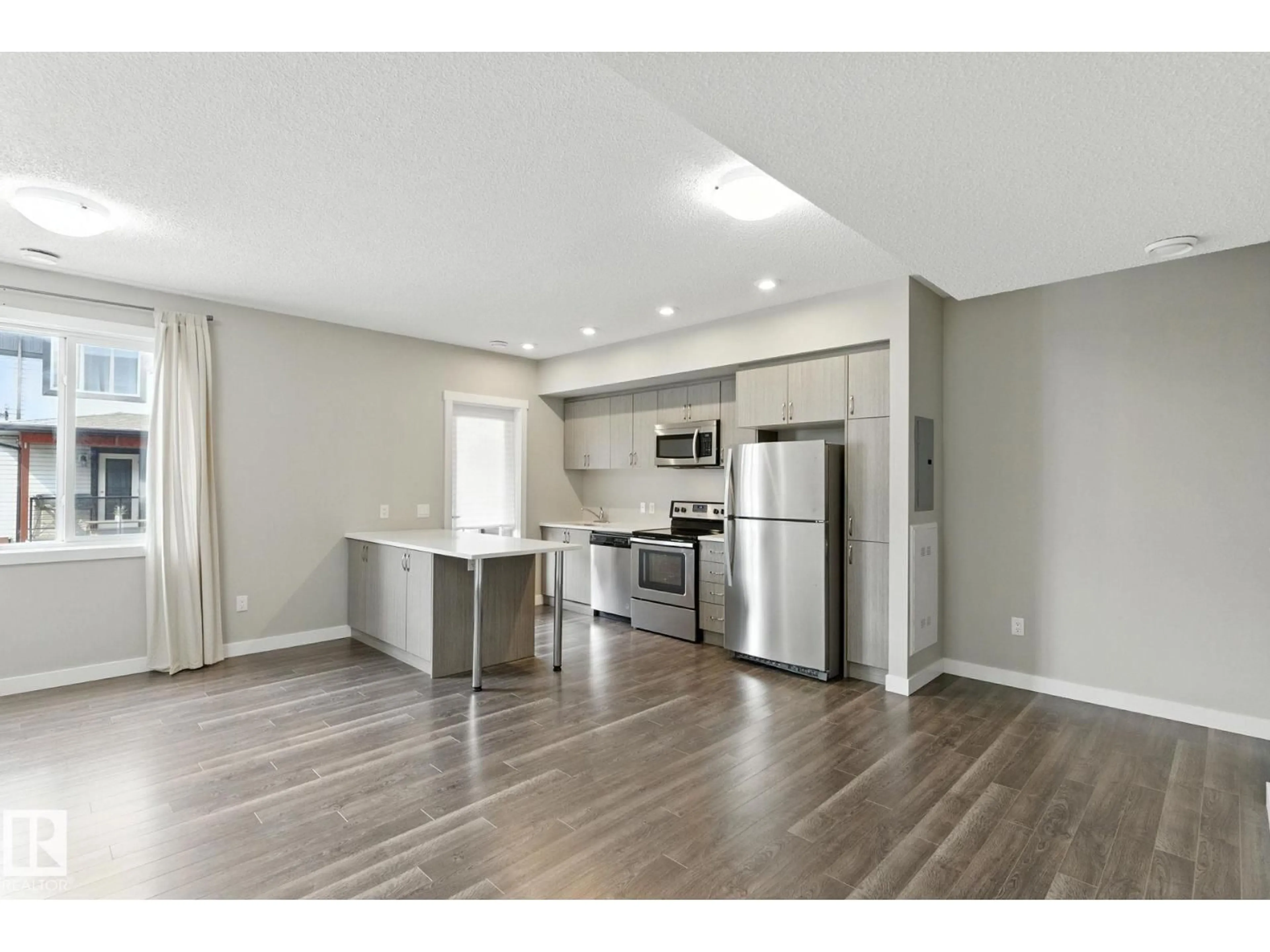 Open concept kitchen, wood/laminate floor for 53 - 446 ALLARD BV, Edmonton Alberta T6W3S7