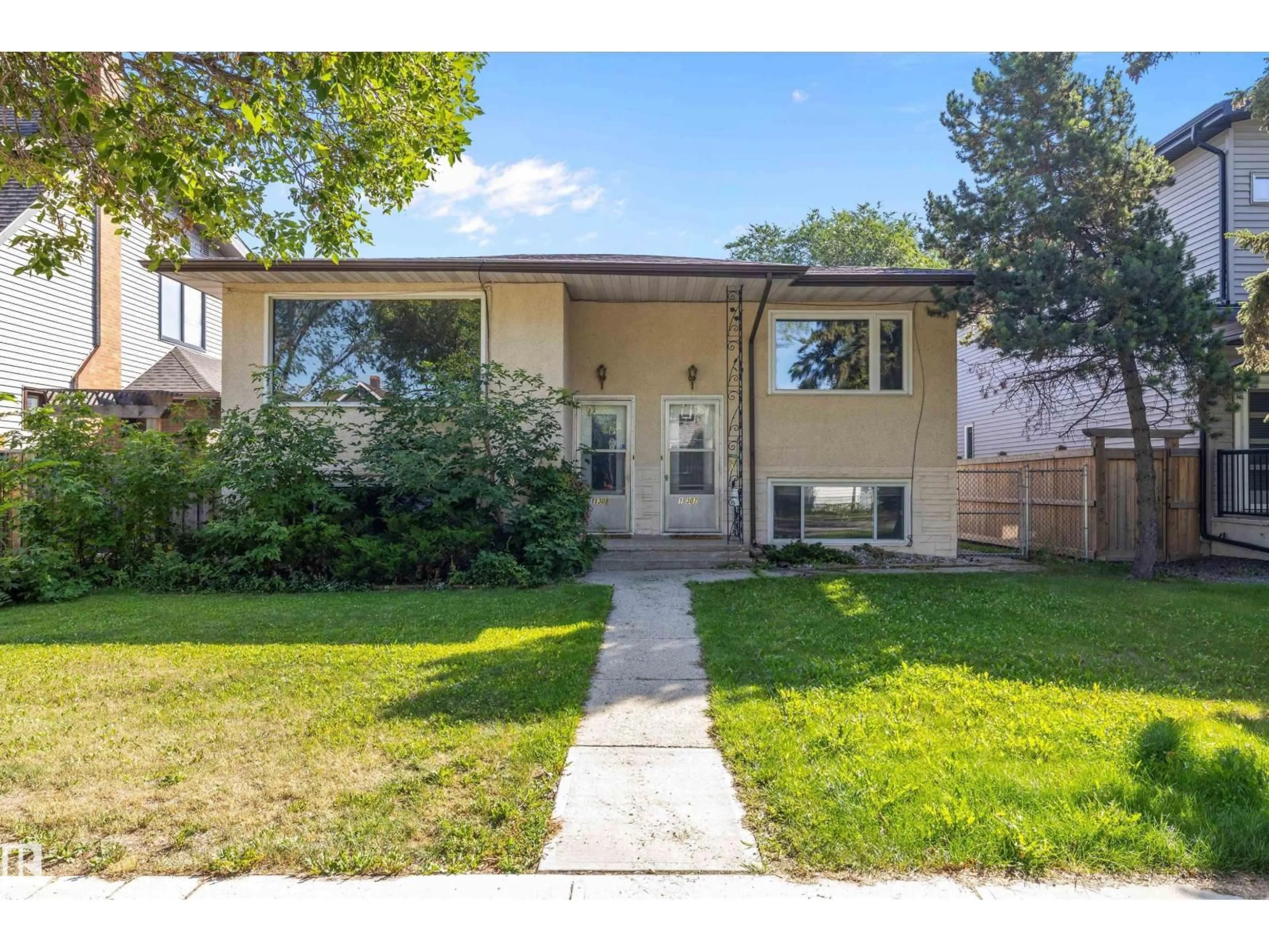 Home with vinyl exterior material, street for NW - 11307 / 11309 127 ST, Edmonton Alberta T5M0T9