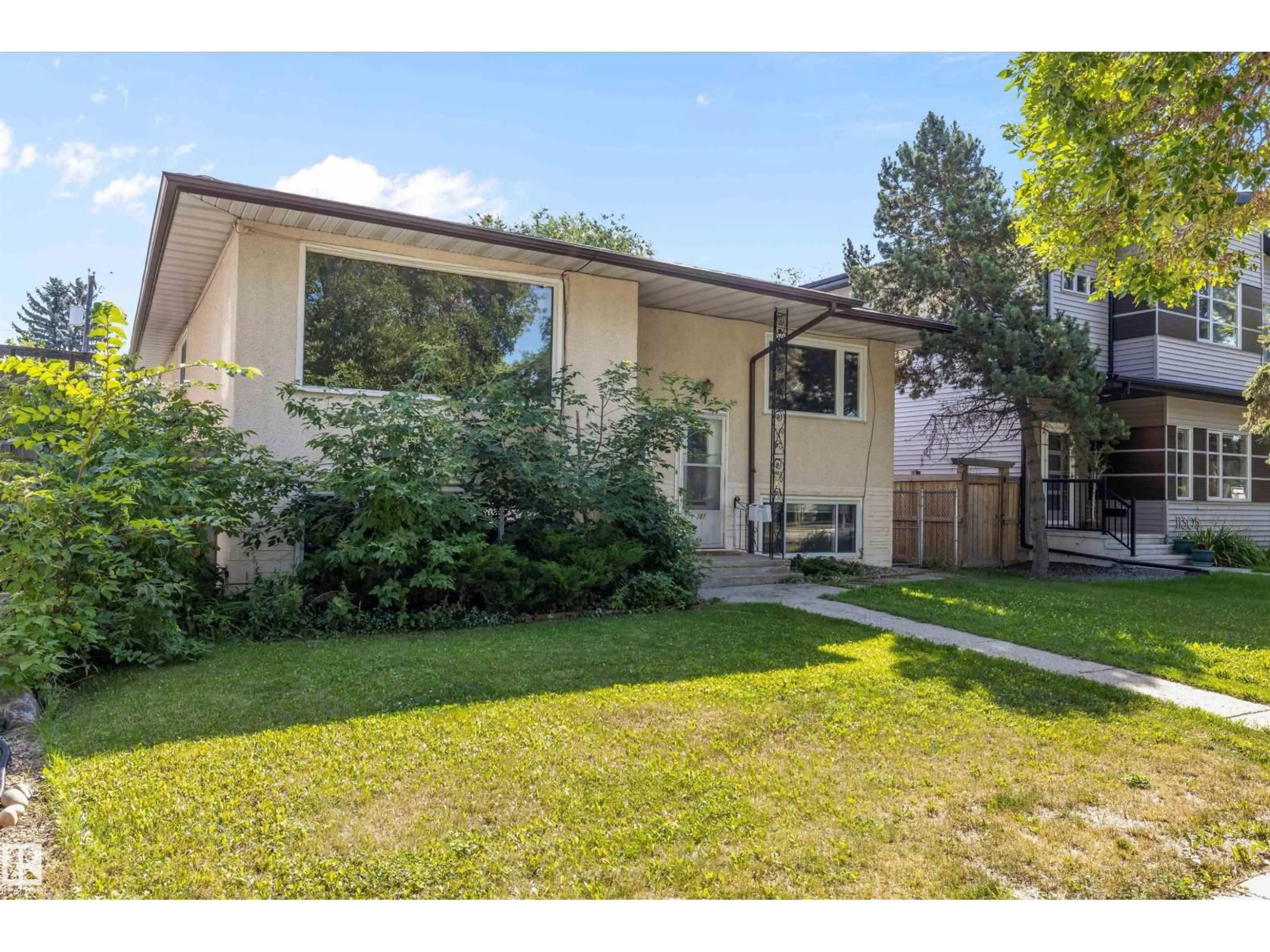 Home with vinyl exterior material, street for NW - 11307 / 11309 127 ST, Edmonton Alberta T5M0T9