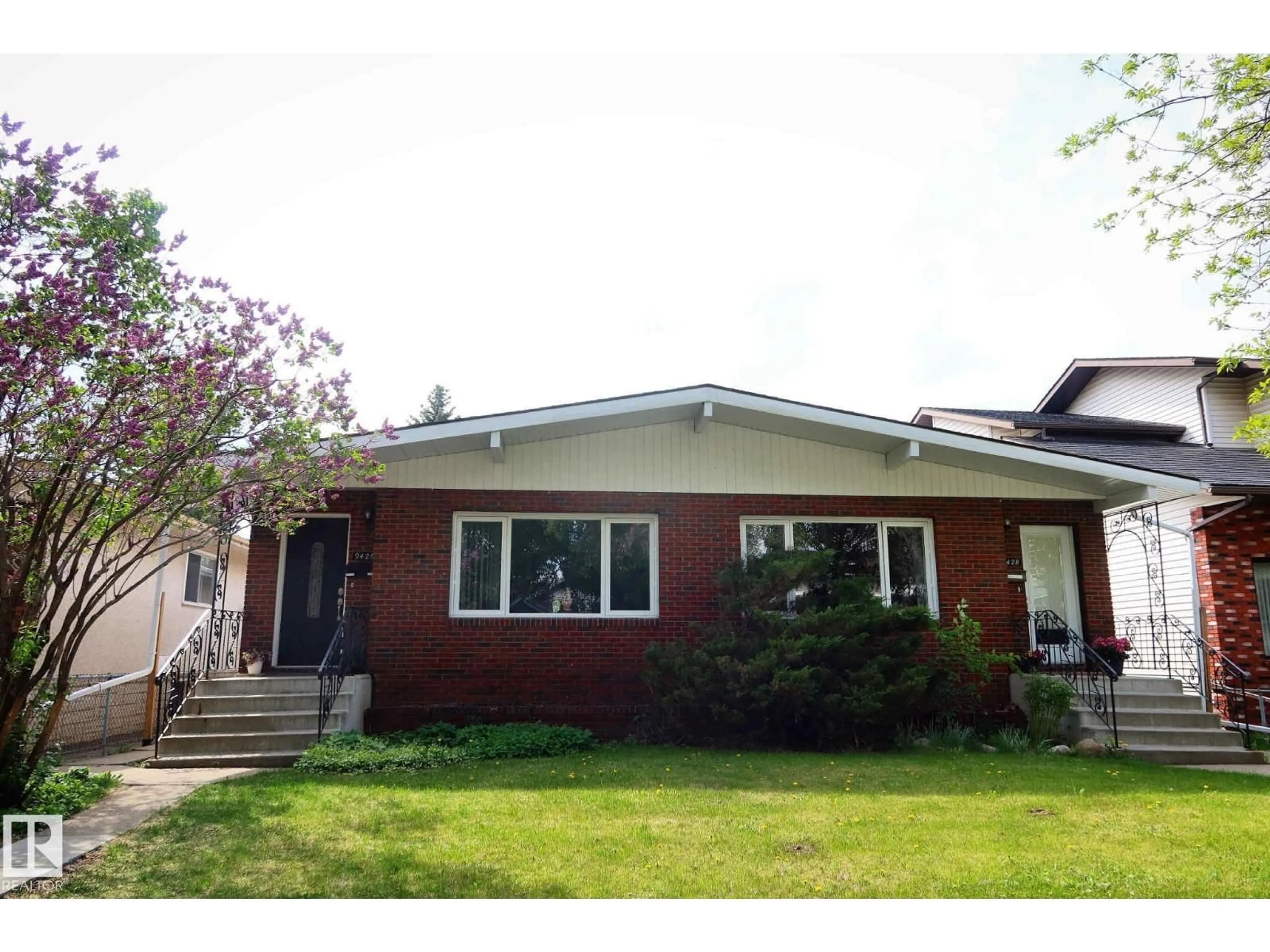 Home with vinyl exterior material, street for 9426/9428 96A ST, Edmonton Alberta T6C3Z7