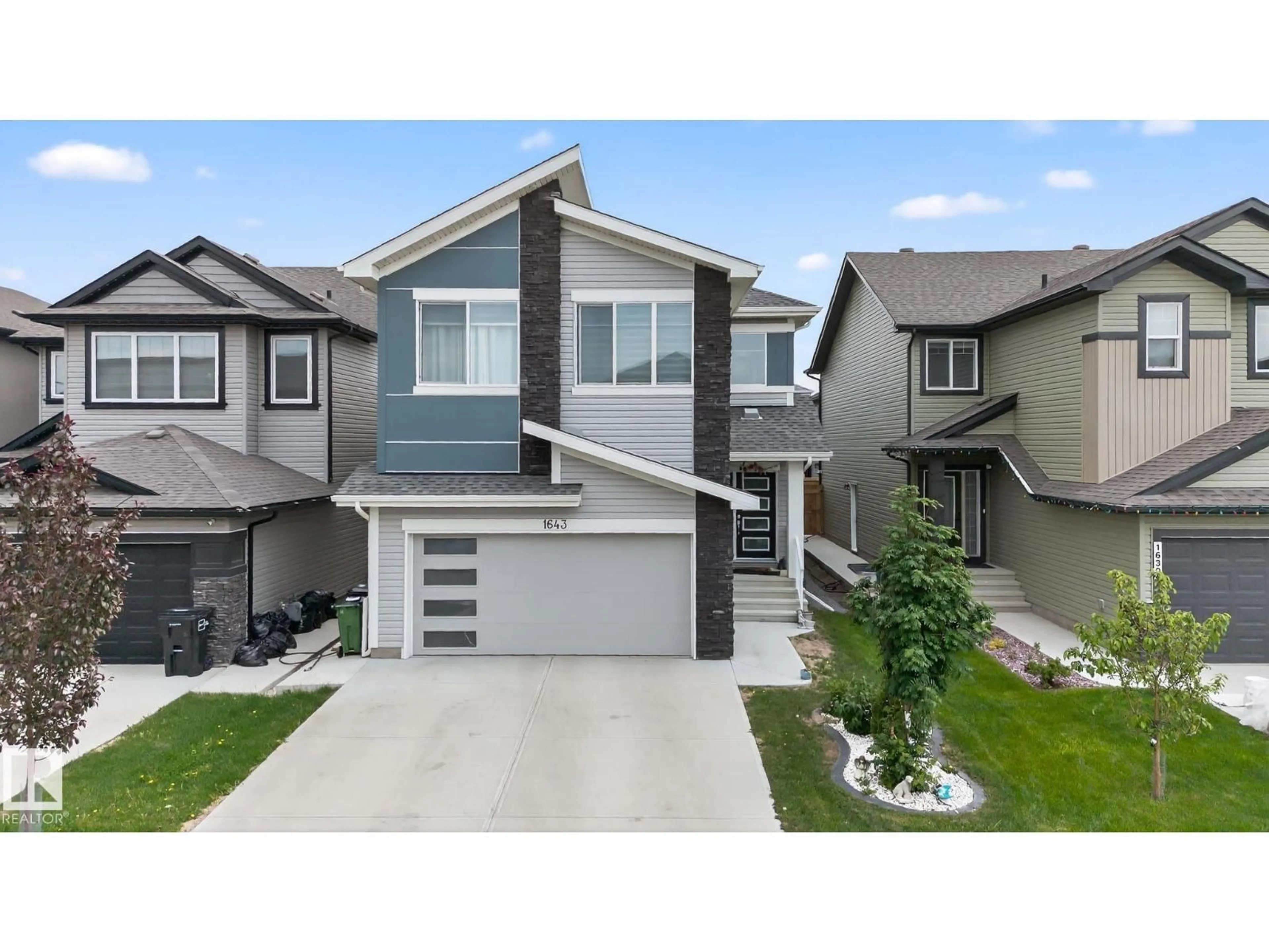 Home with vinyl exterior material, street for 1643 14 ST, Edmonton Alberta T6T2N6