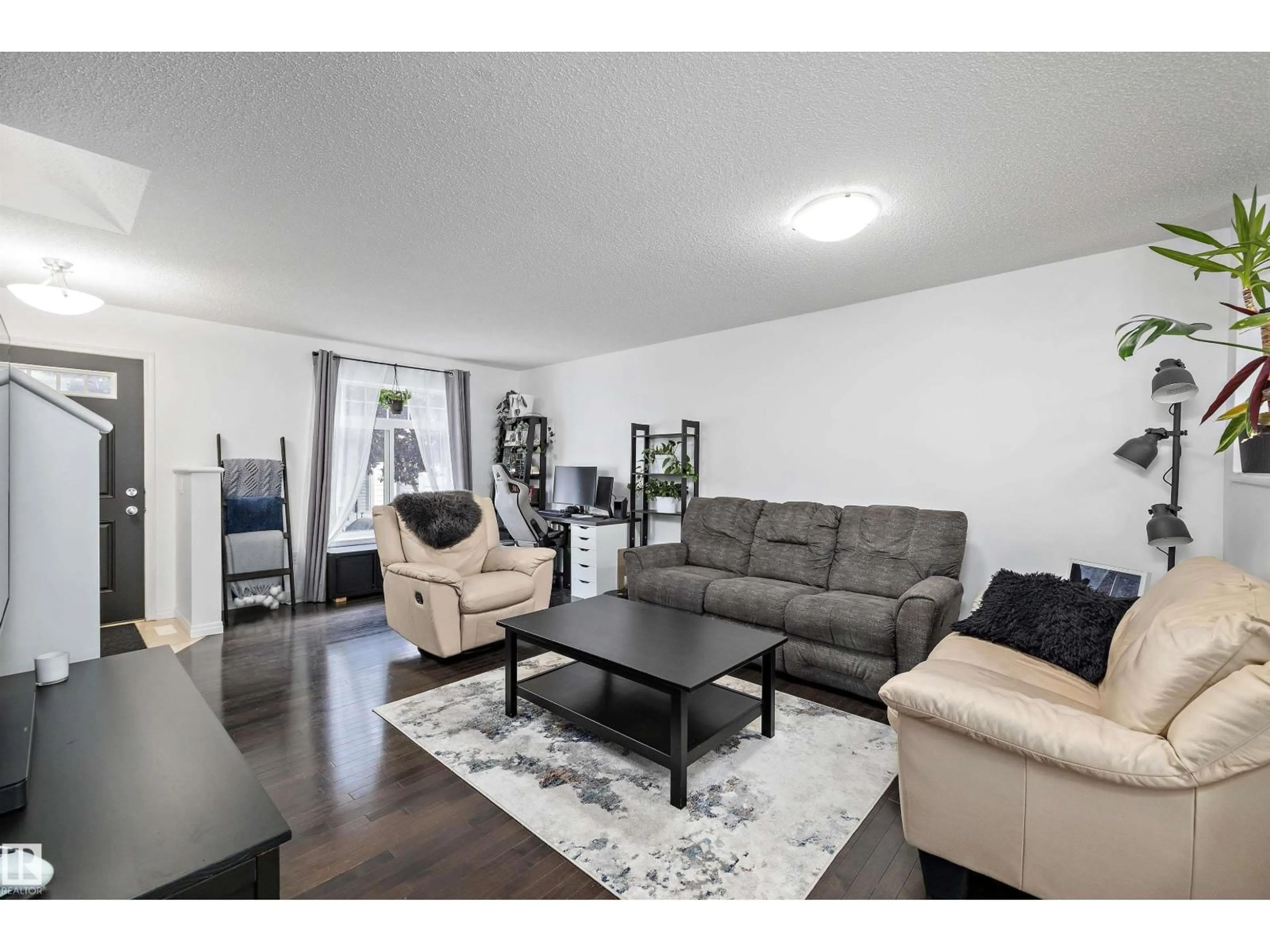 Living room with furniture, wood/laminate floor for 465 - 16 HEMINGWAY RD, Edmonton Alberta T6M0J7