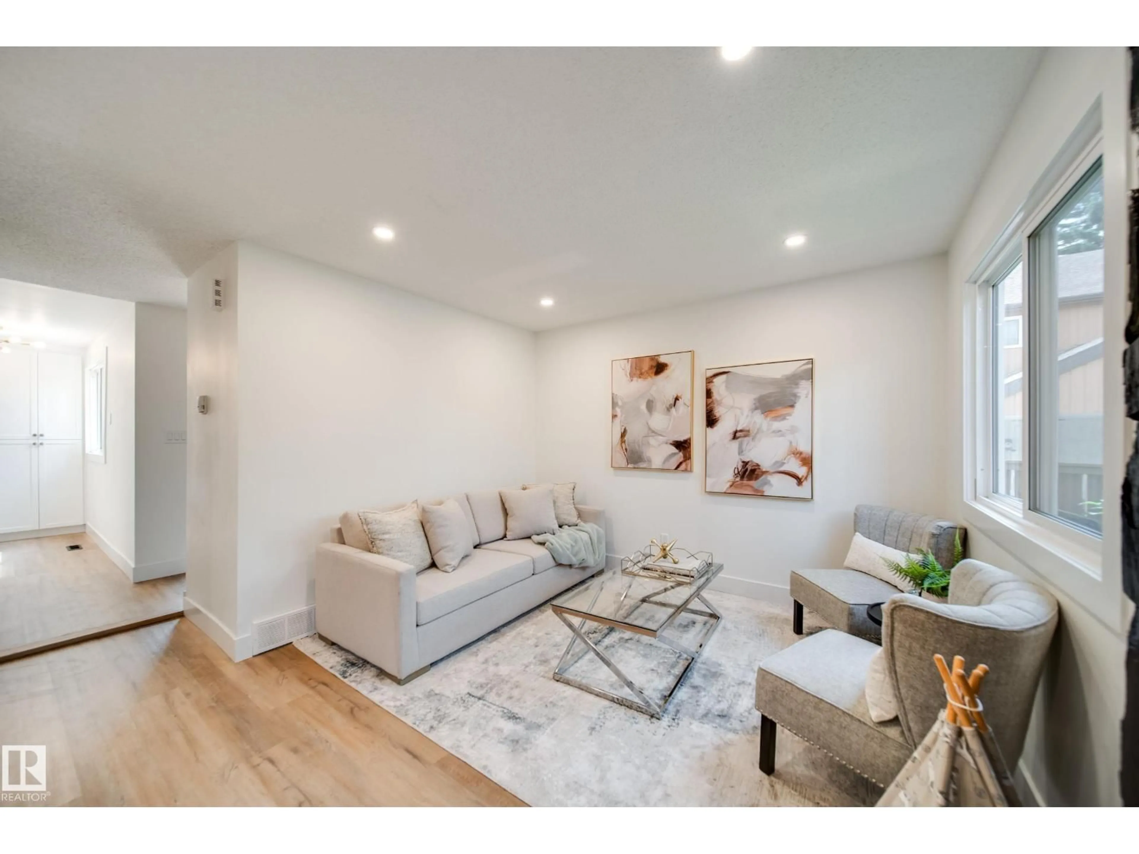 Living room with furniture, wood/laminate floor for 6098 MILL WOODS NW, Edmonton Alberta T6L1N5