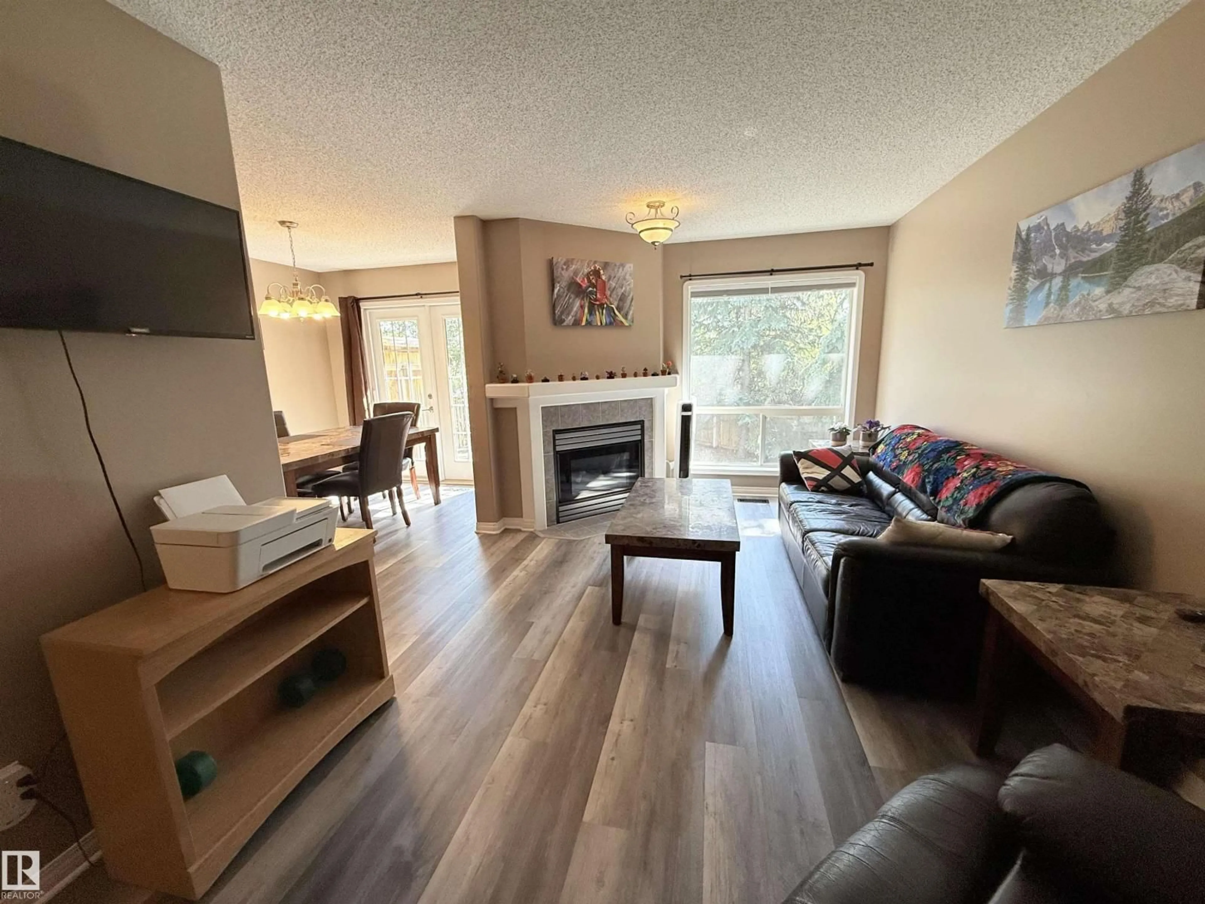 Living room with furniture, wood/laminate floor for NW - 17053 113 ST, Edmonton Alberta T5X5Y9