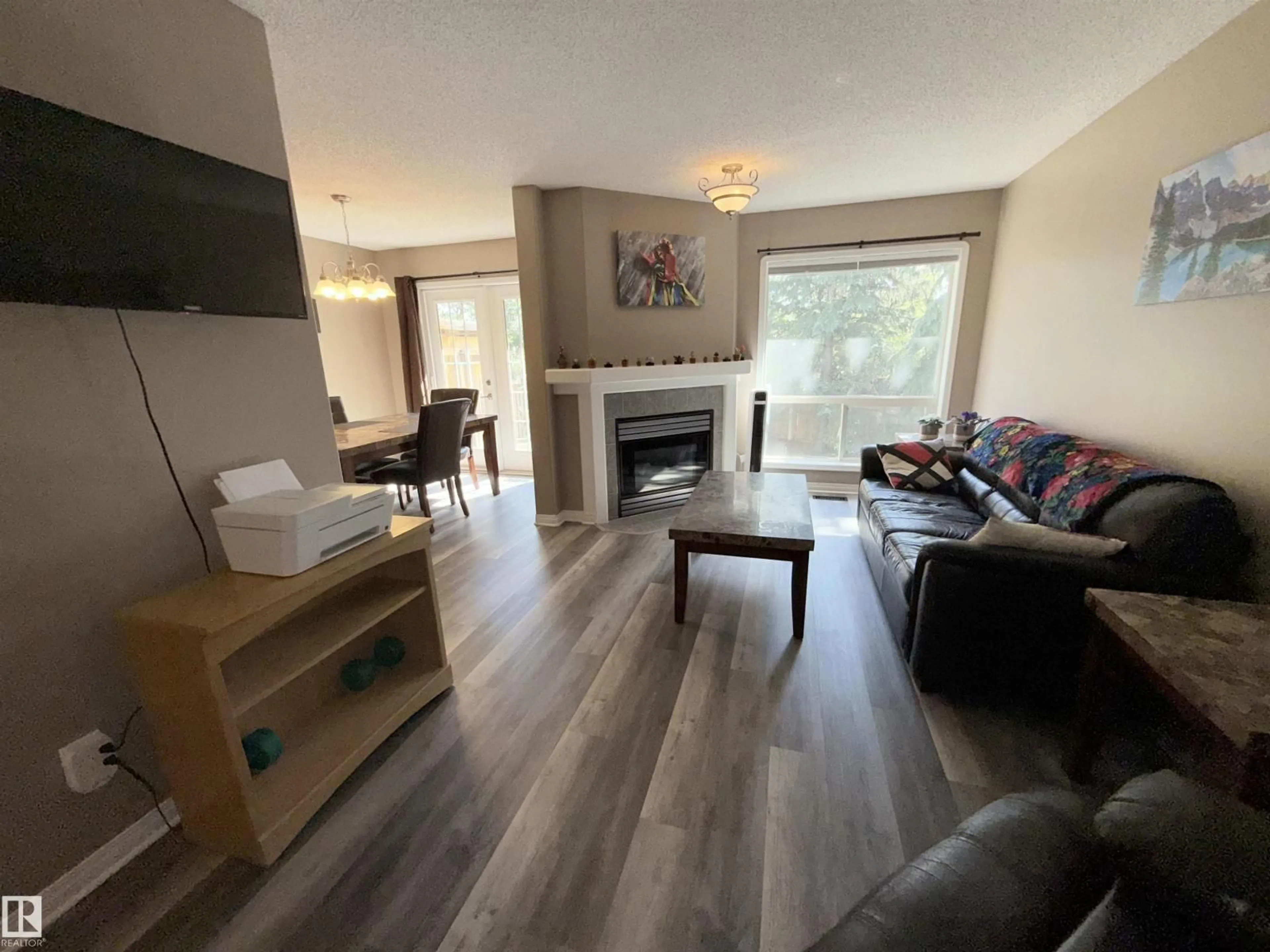 Living room with furniture, wood/laminate floor for NW - 17053 113 ST, Edmonton Alberta T5X5Y9