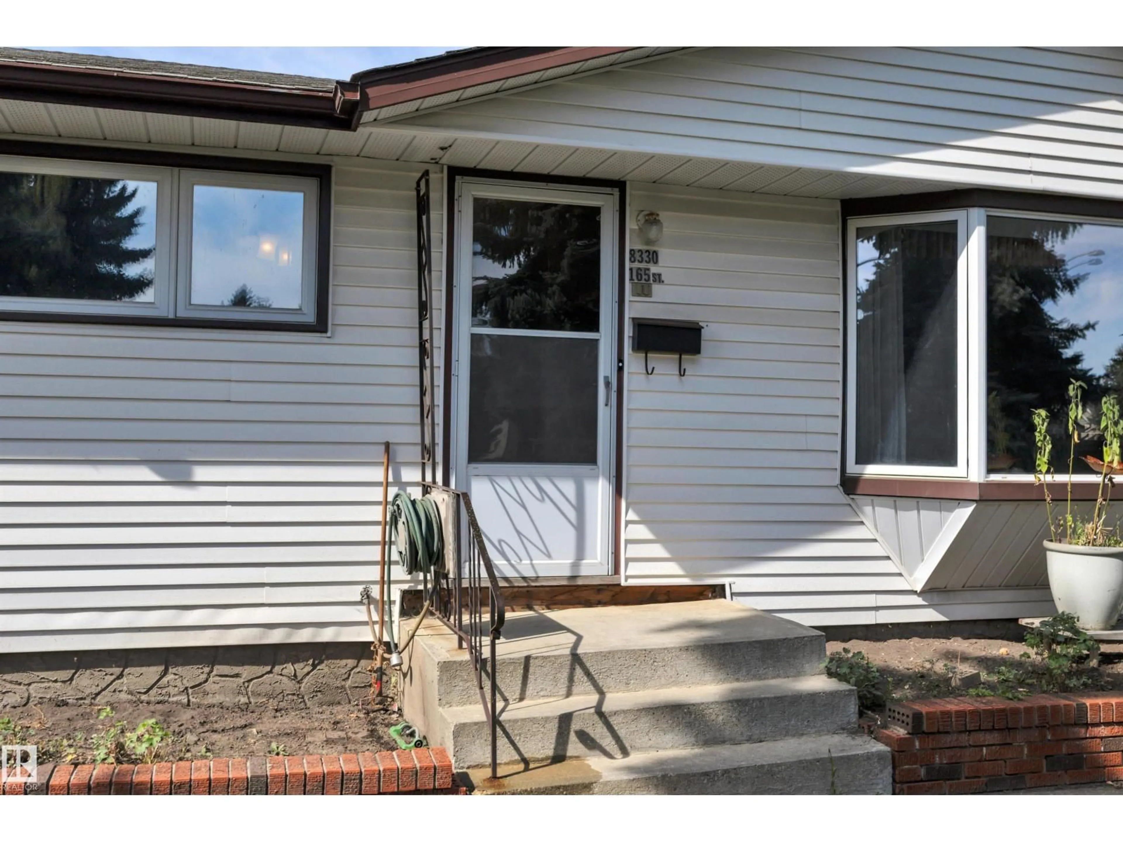 Home with vinyl exterior material, street for 8330 165 ST, Edmonton Alberta T5R2R4