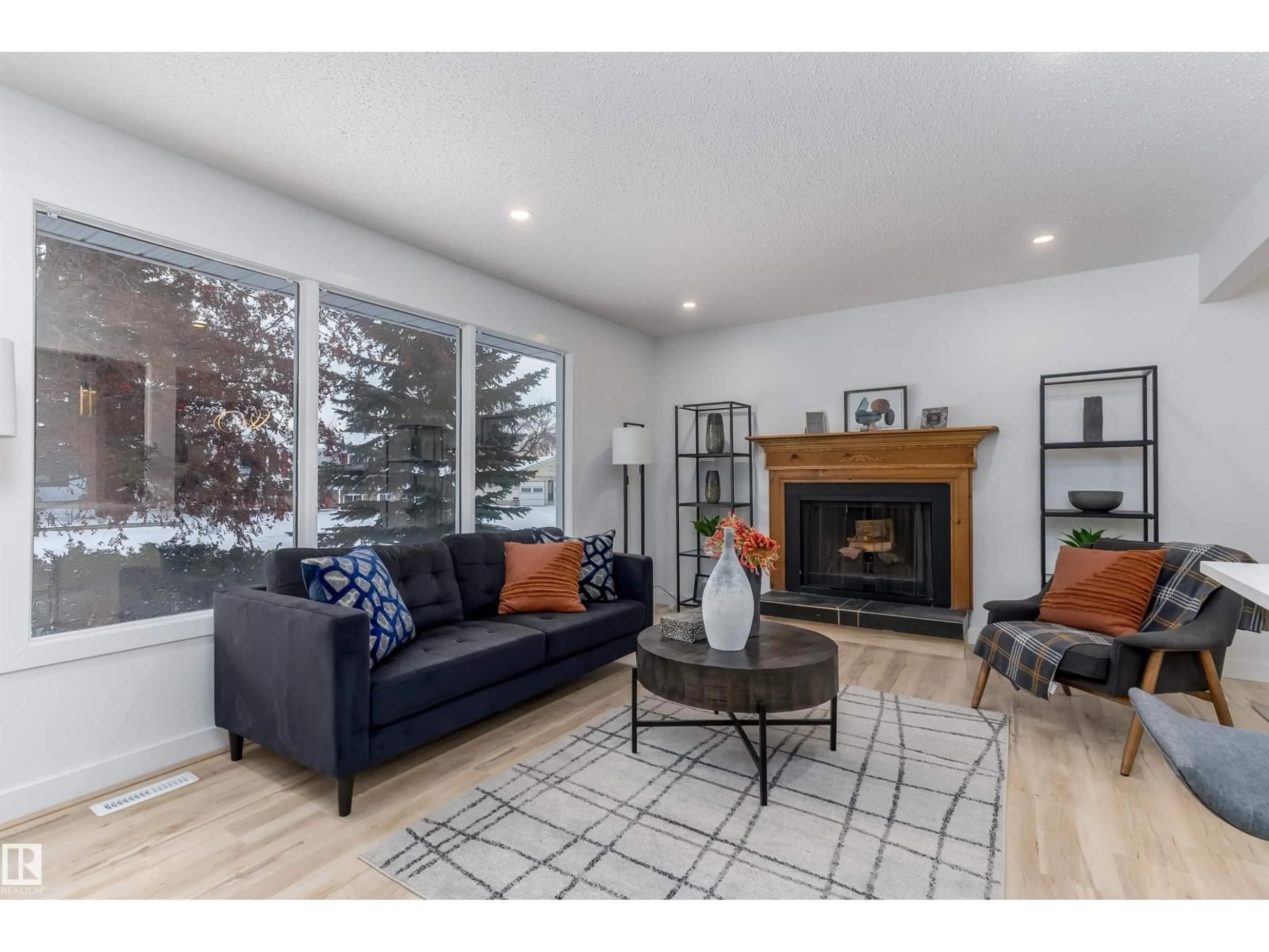 Living room with furniture, wood/laminate floor for 8104 17 AV, Edmonton Alberta T6K2C8