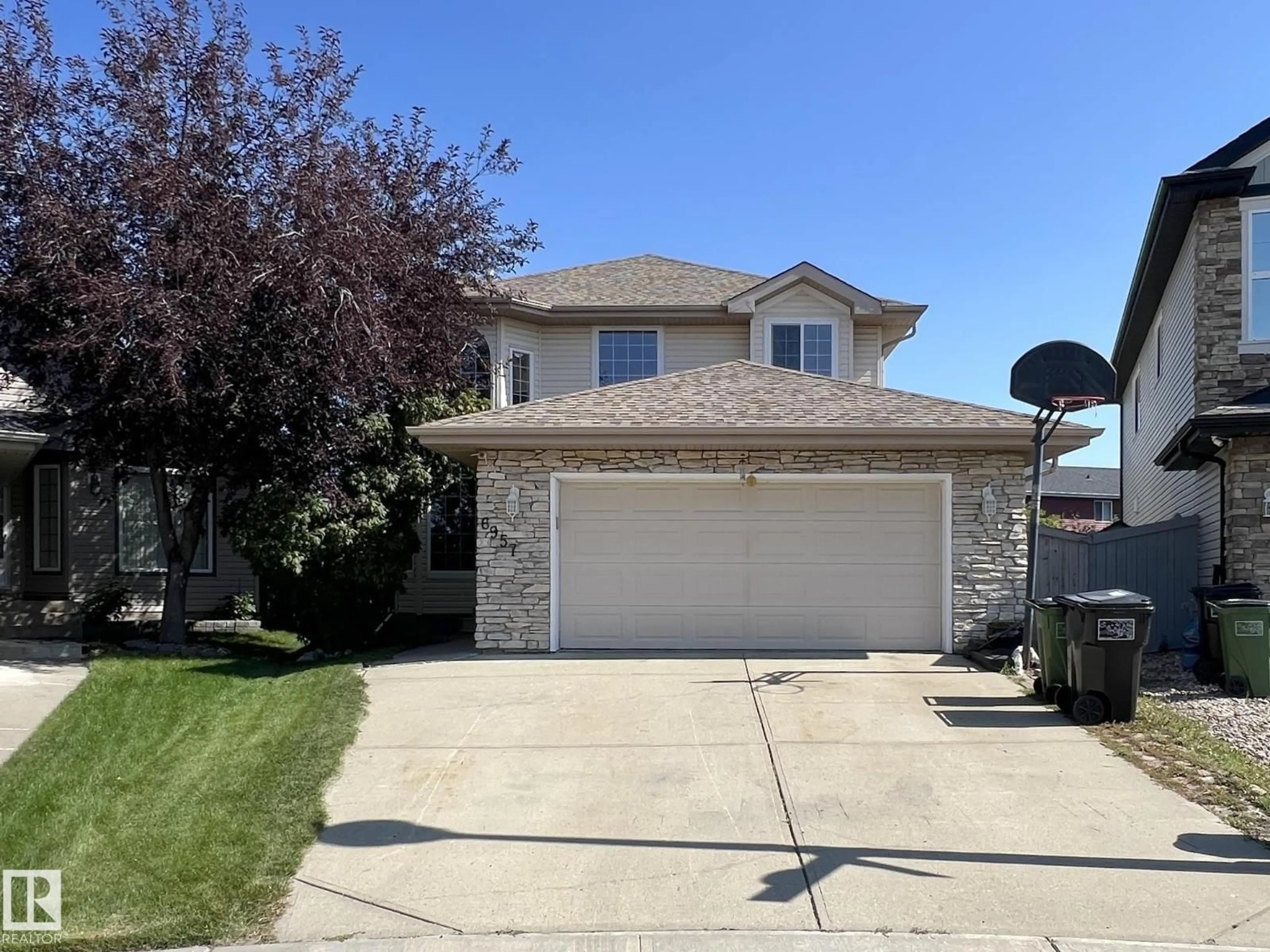 Home with vinyl exterior material, street for 6957 STROM LN, Edmonton Alberta T6R0J9