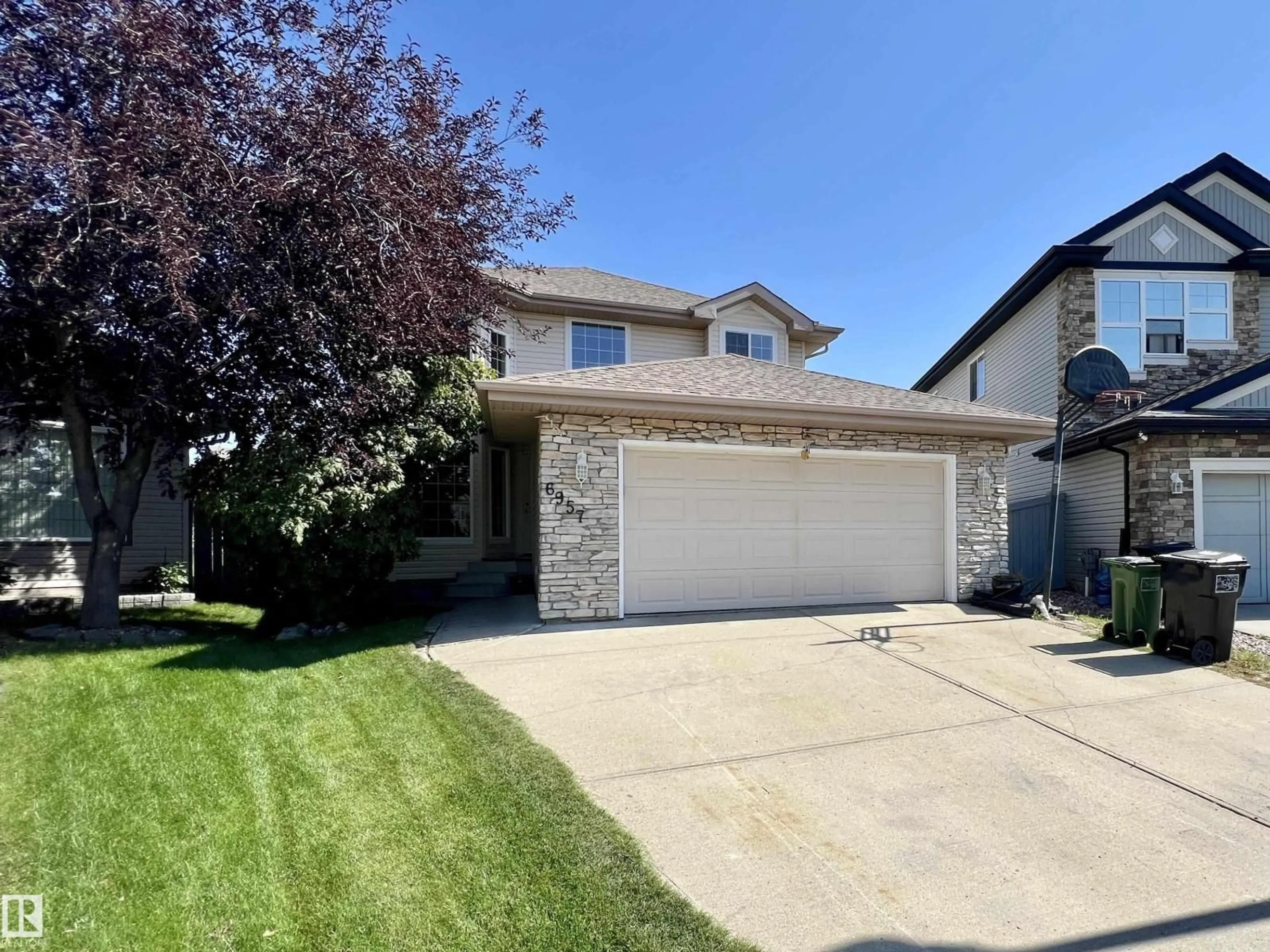 Home with vinyl exterior material, street for 6957 STROM LN, Edmonton Alberta T6R0J9