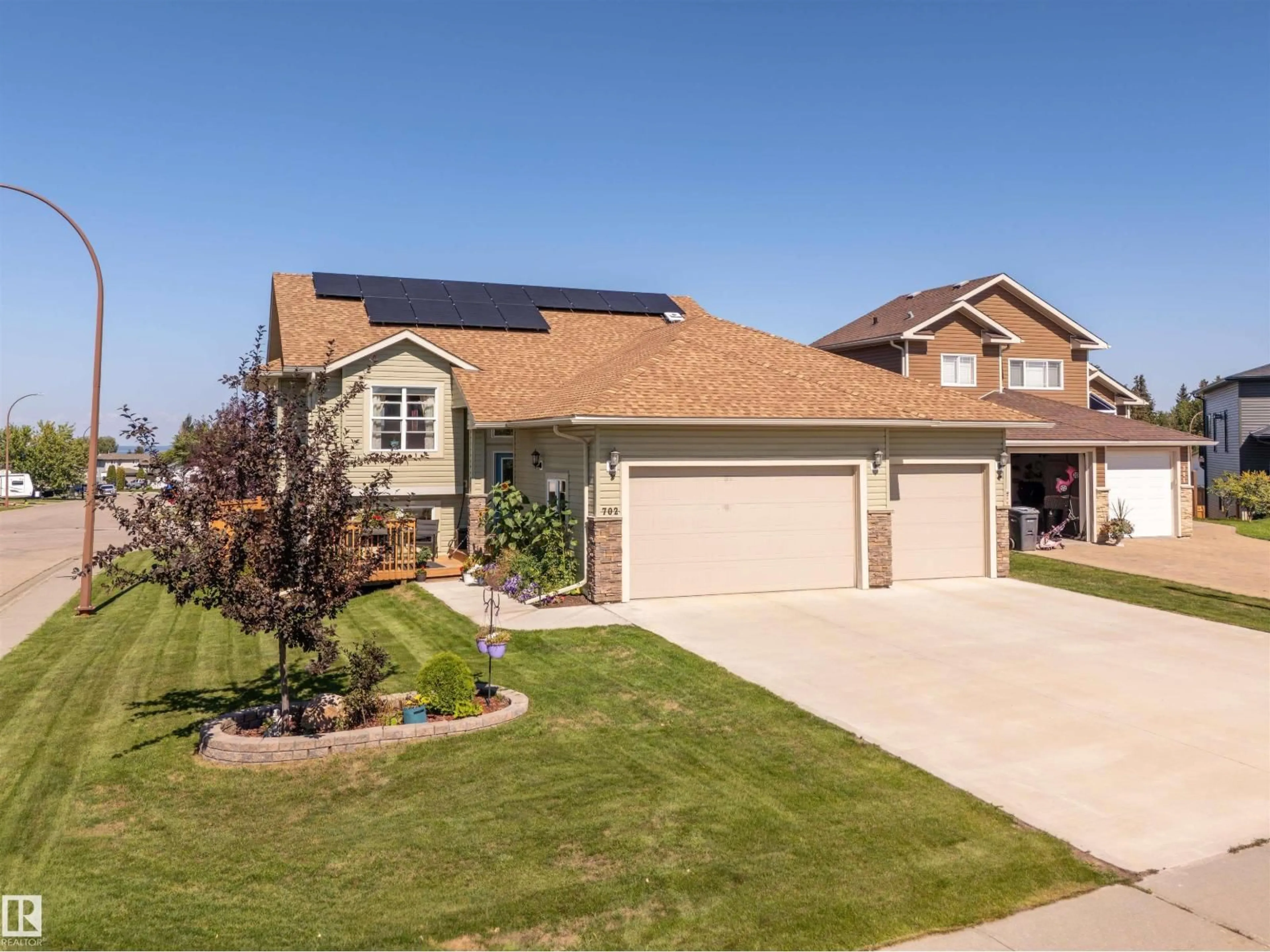 Home with vinyl exterior material, street for 702 PHEASANT CL, Cold Lake Alberta T9M0B7