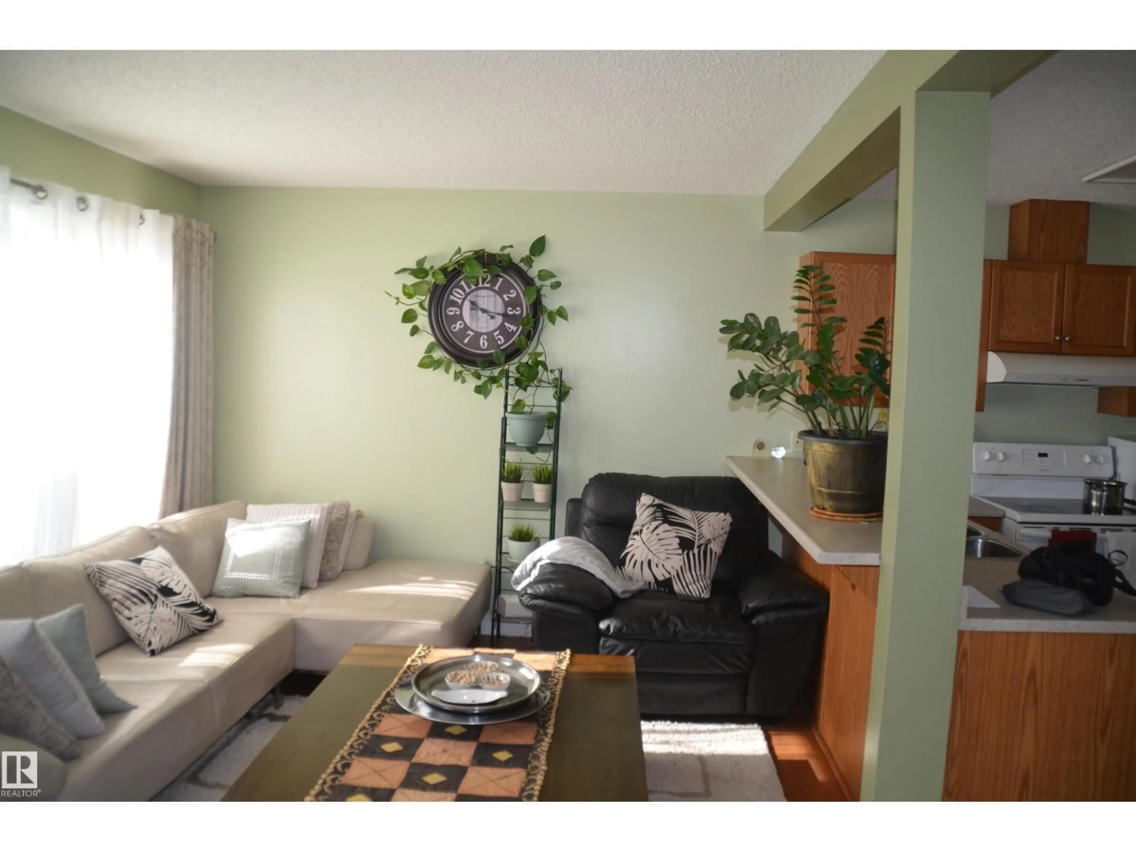 Living room with furniture, wood/laminate floor for NW - 25 14603 MILLER BV, Edmonton Alberta T5Y3B6