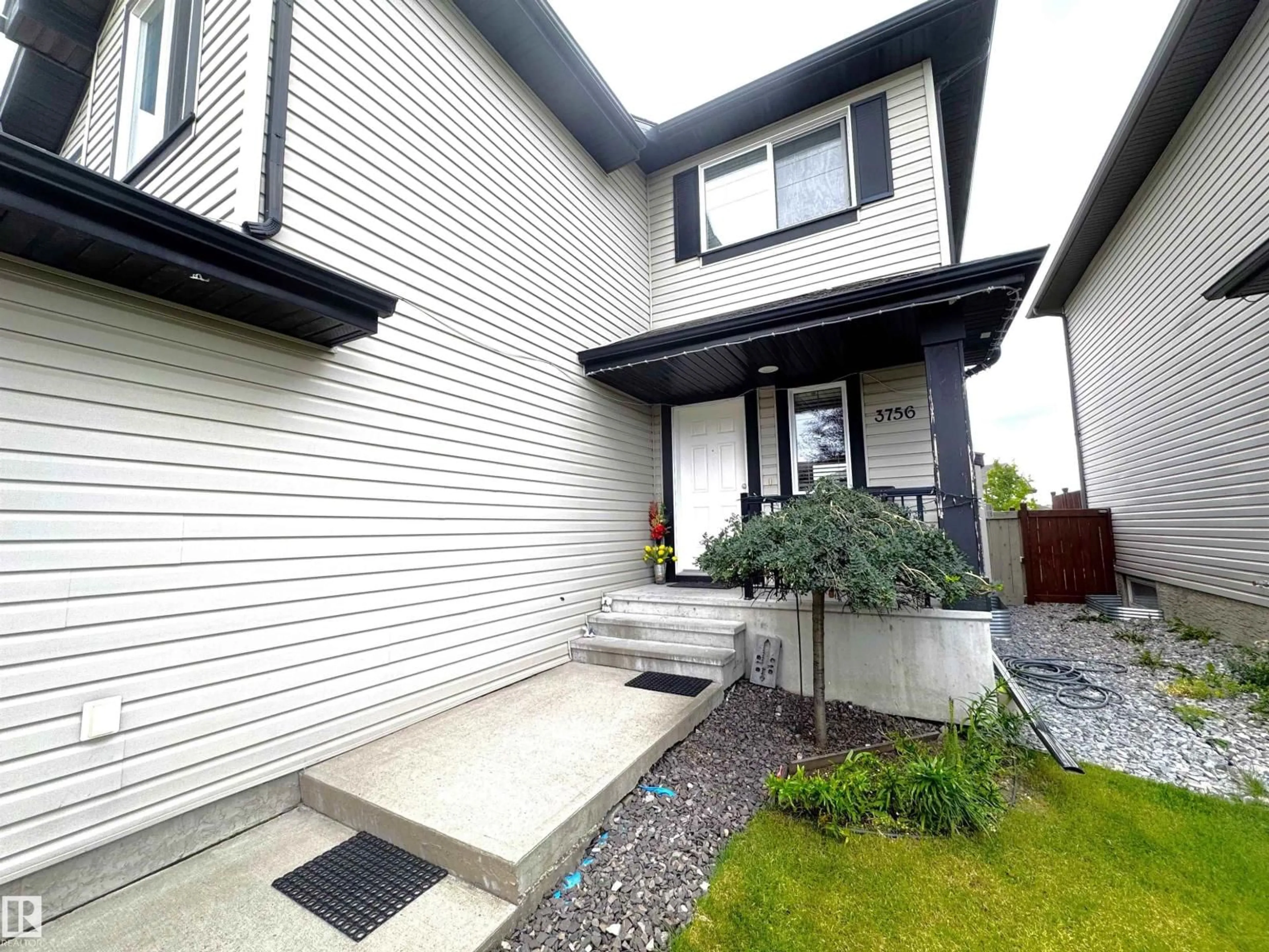 Home with vinyl exterior material, street for 3756 13 ST, Edmonton Alberta T6T0E5