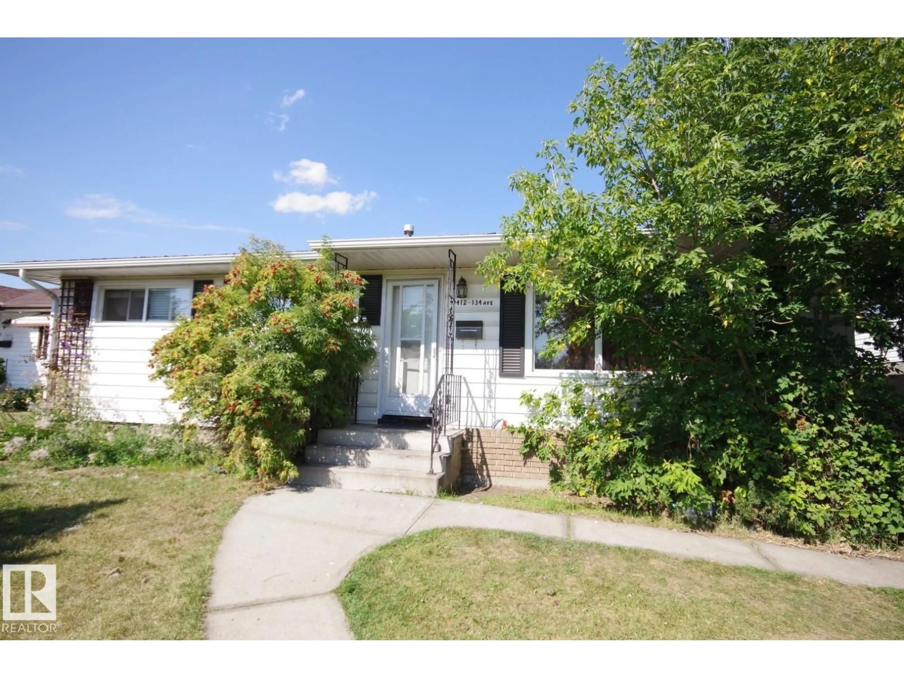 Home with vinyl exterior material, street for 9412 134 AV, Edmonton Alberta T5E1H7