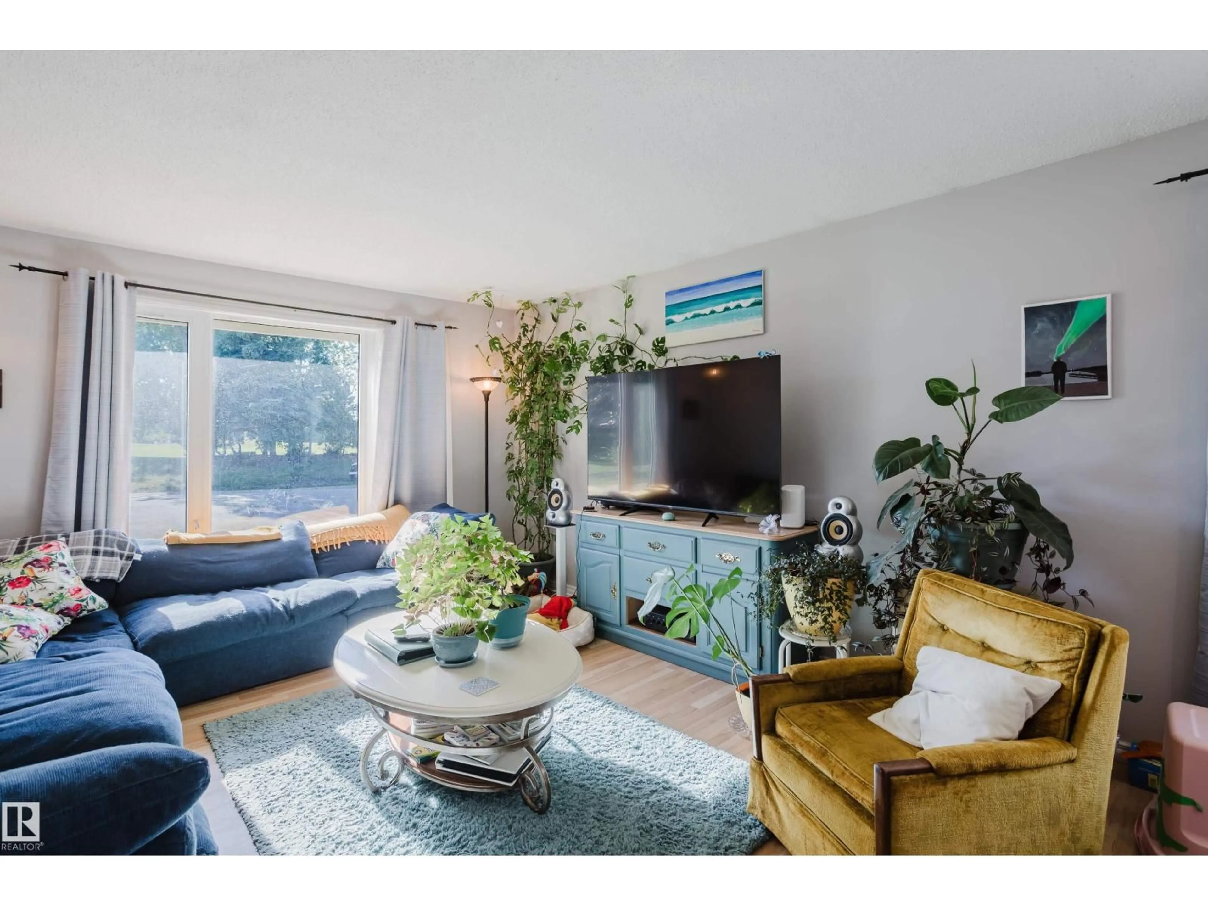Living room with furniture, wood/laminate floor for 9301 81A ST, Fort Saskatchewan Alberta T8L3M2