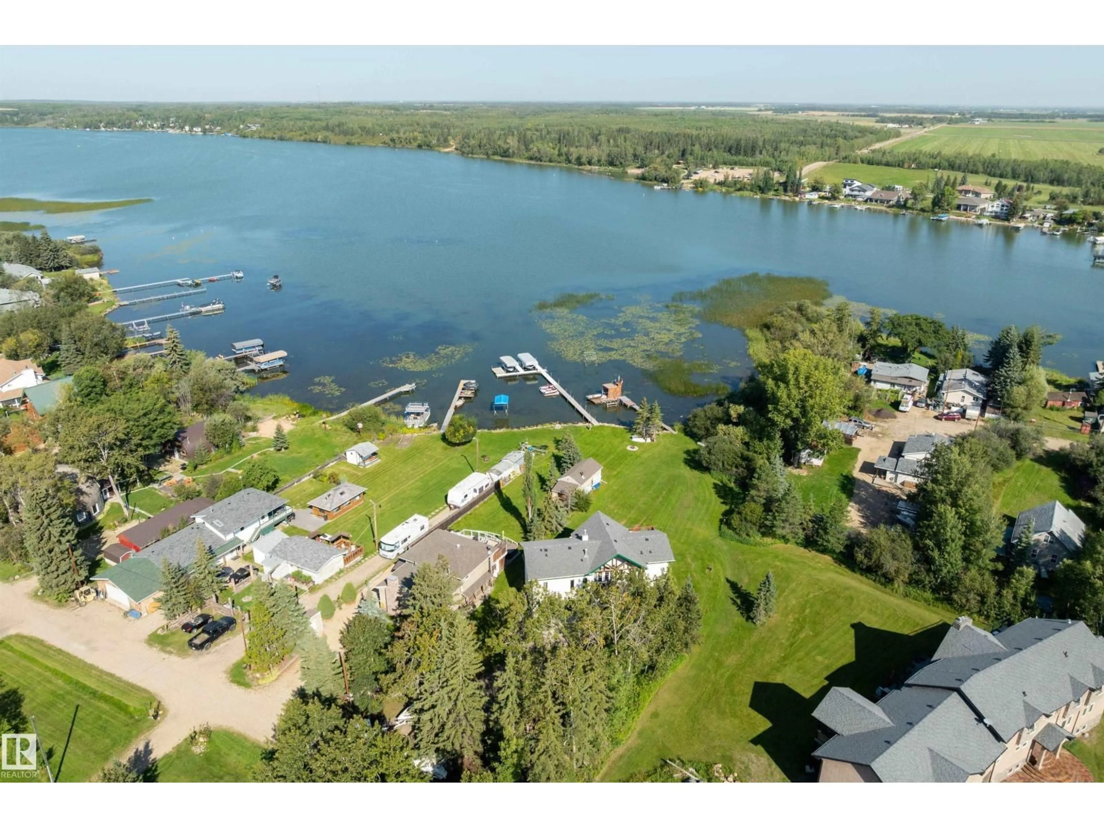 A pic from outside/outdoor area/front of a property/back of a property/a pic from drone, water/lake/river/ocean view for 120 48003 RR271, Rural Leduc County Alberta T0C2P0