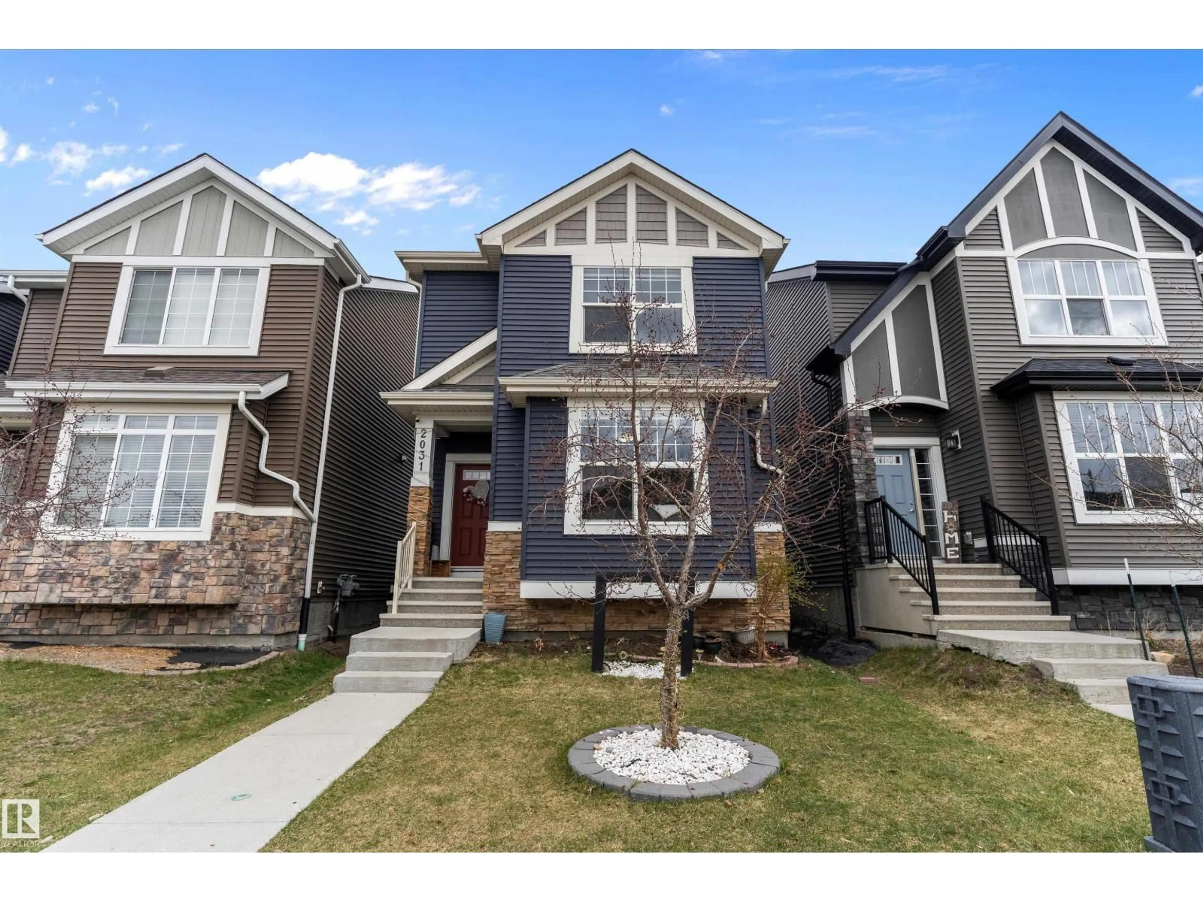 Home with vinyl exterior material, street for 2031 52 STREET, Edmonton Alberta T6X1Z7